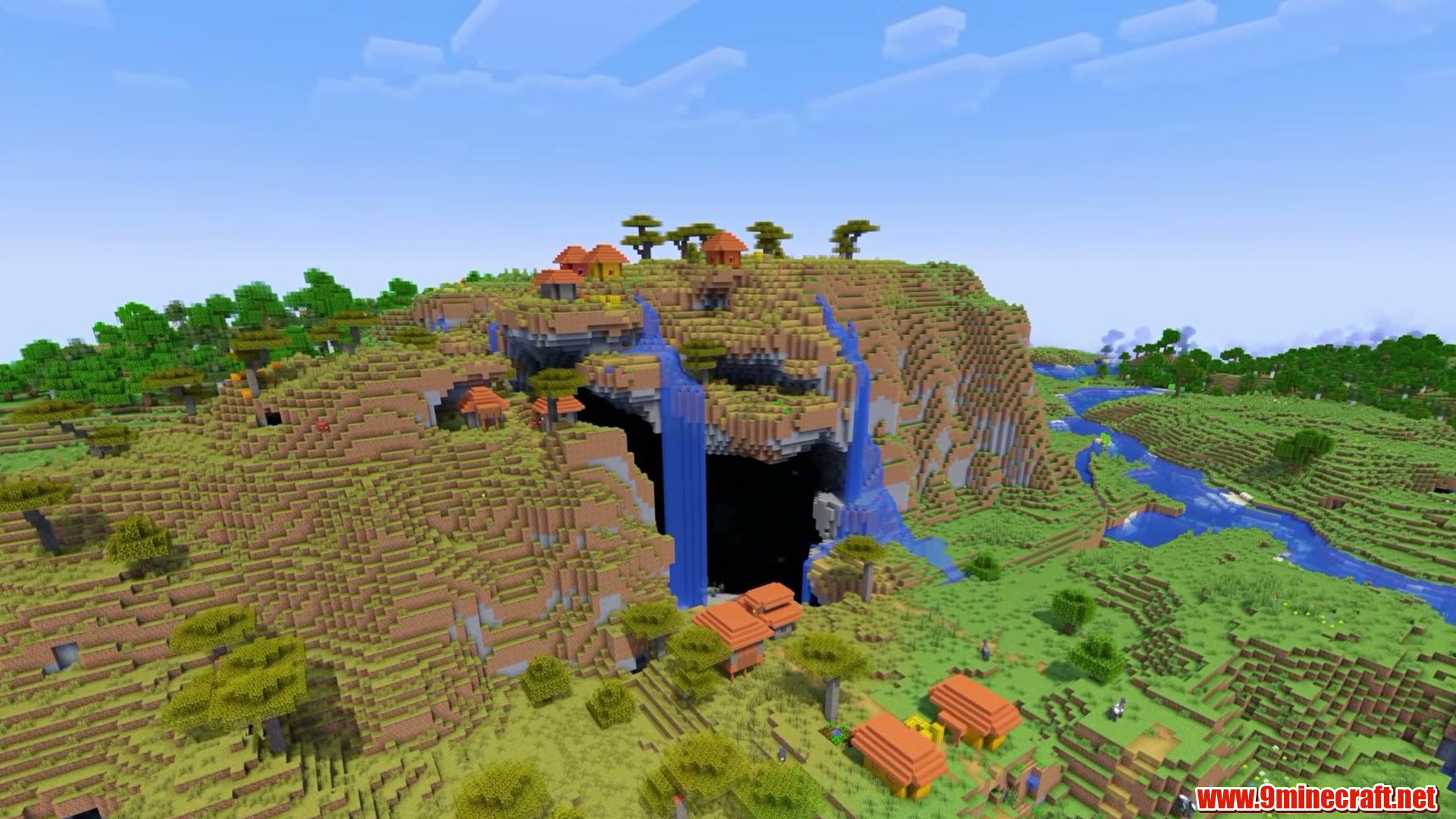 Village in front of a huge cave arch in Minecraft seed 225237899
