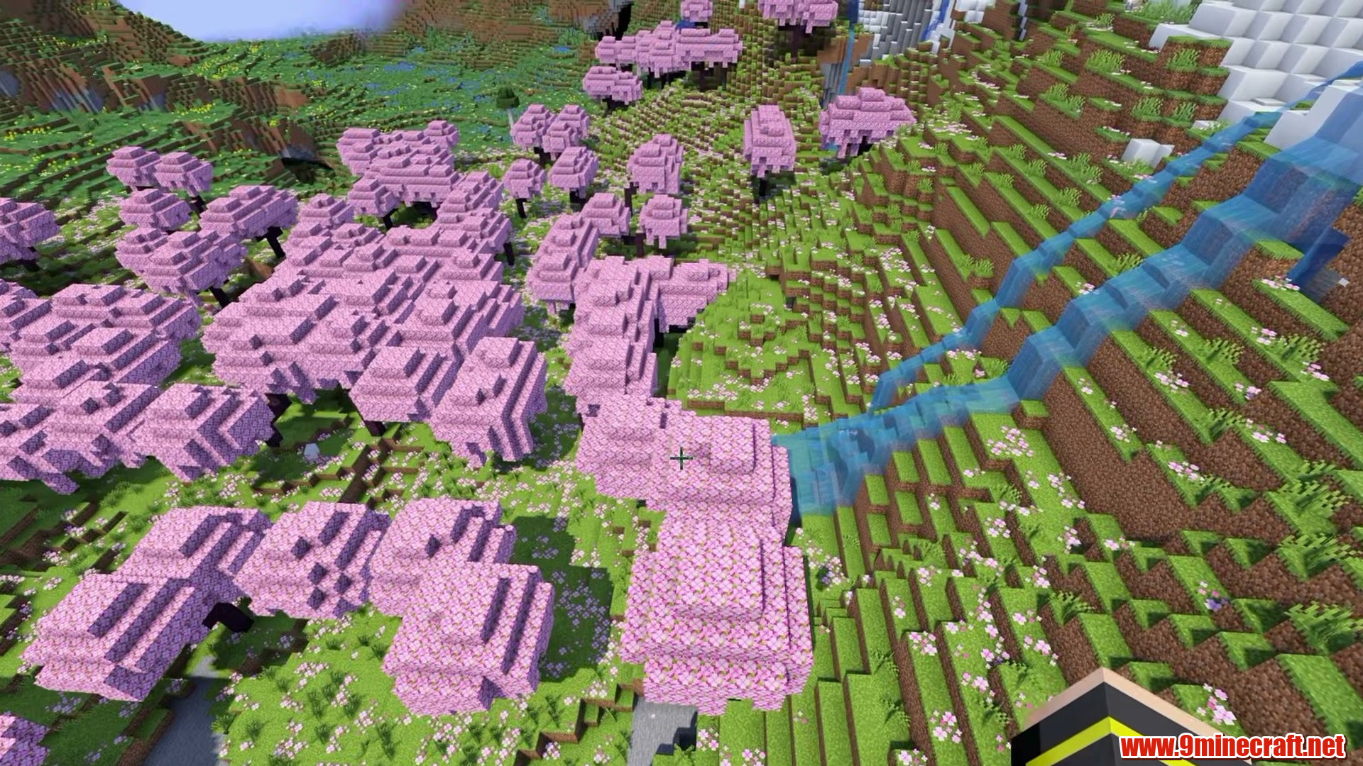 Pink cherry canopy against the stone peaks