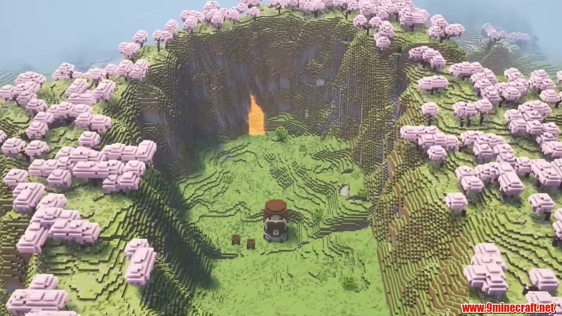 Wide aerial view of the pillager tower and lava fall inside a cherry grove crater