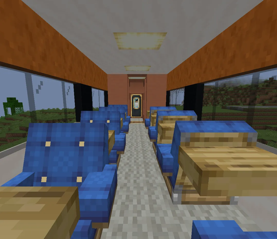 Modern train interior featuring rows of blue passenger seats and wooden tables