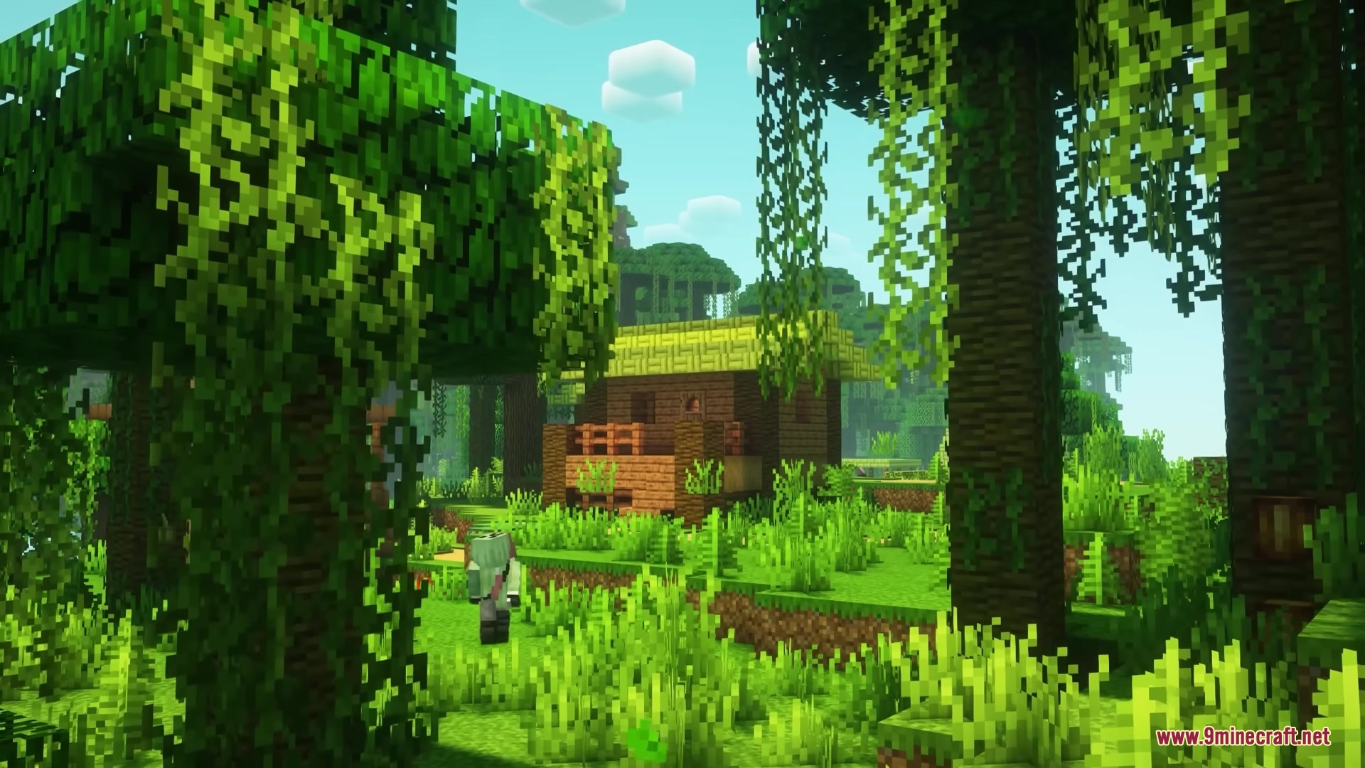 A player character walks through a lush jungle towards a small wooden house