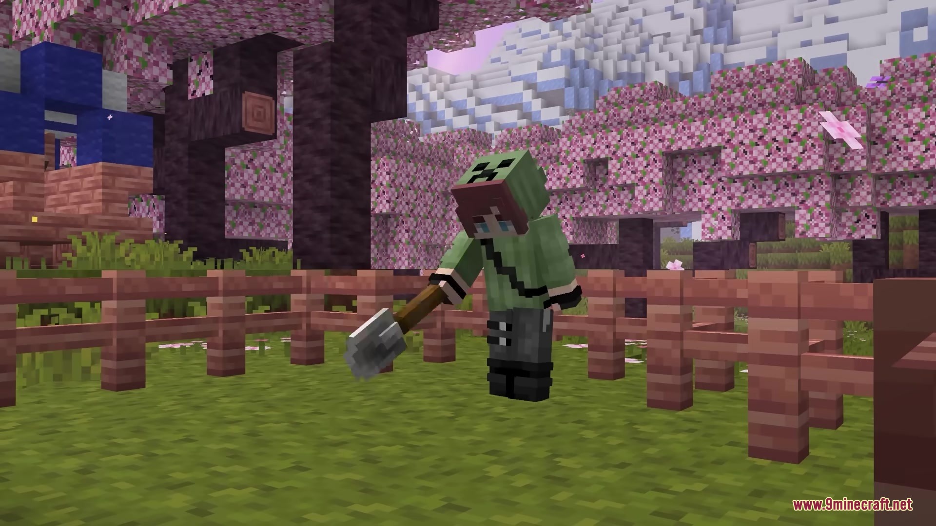 A player character holding a detailed 3D shovel near a wooden fence