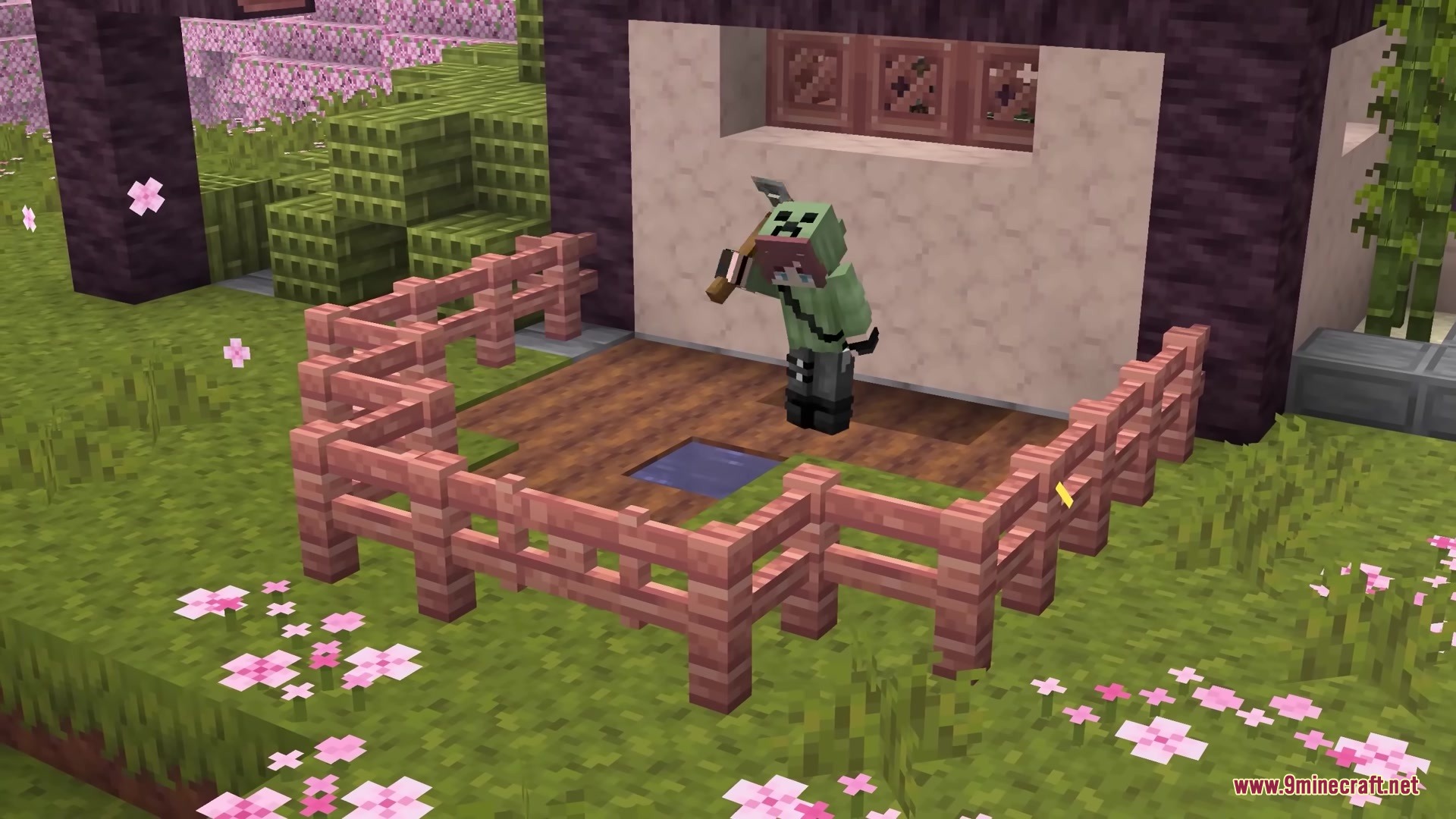 Player character holding a 3D axe model while standing in a fenced garden