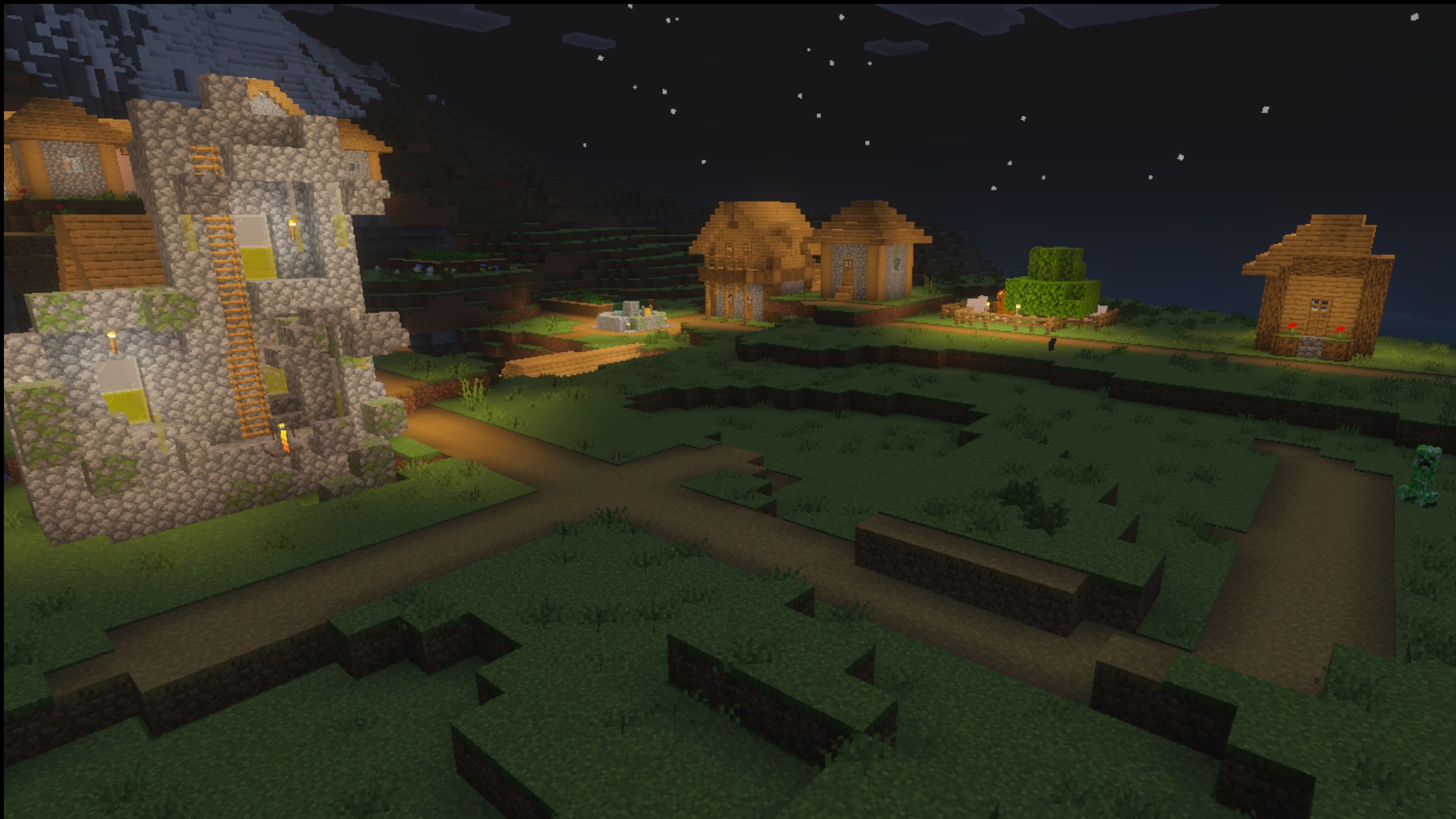 The village at night showing lighting and glowing blocks in the Ultimate Survival pack