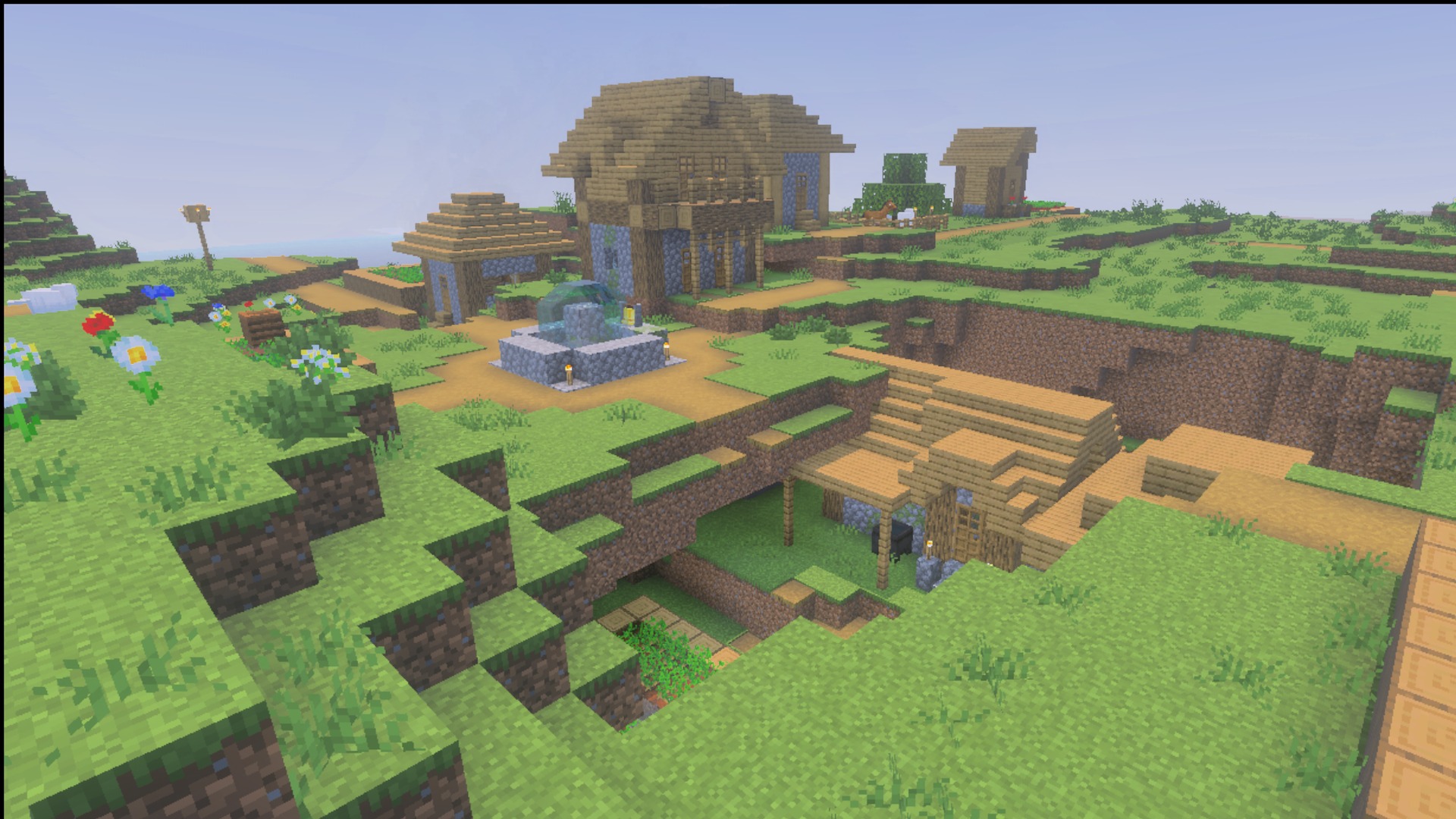 Village buildings and a fountain in daylight showing the Ultimate Survival block textures