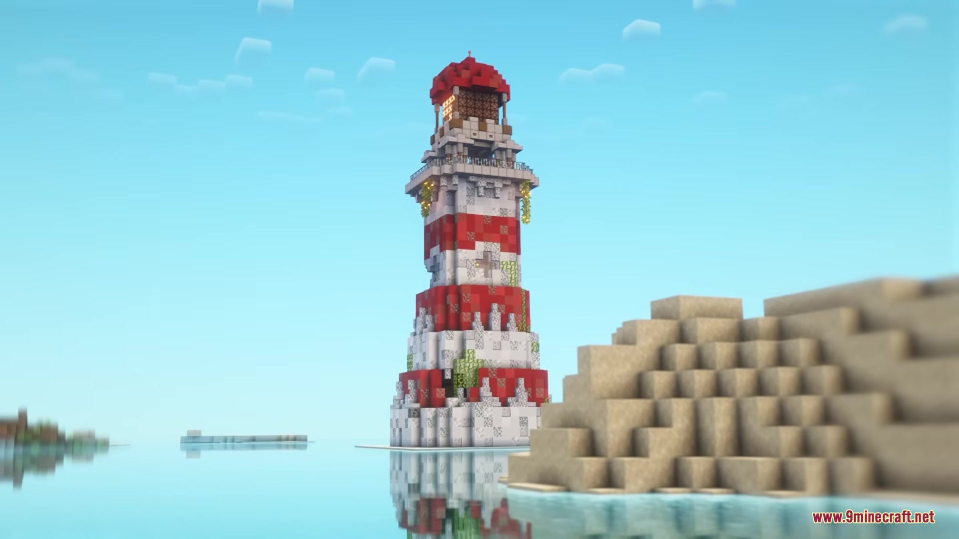 A tall red and white lighthouse standing on a small island in the ocean