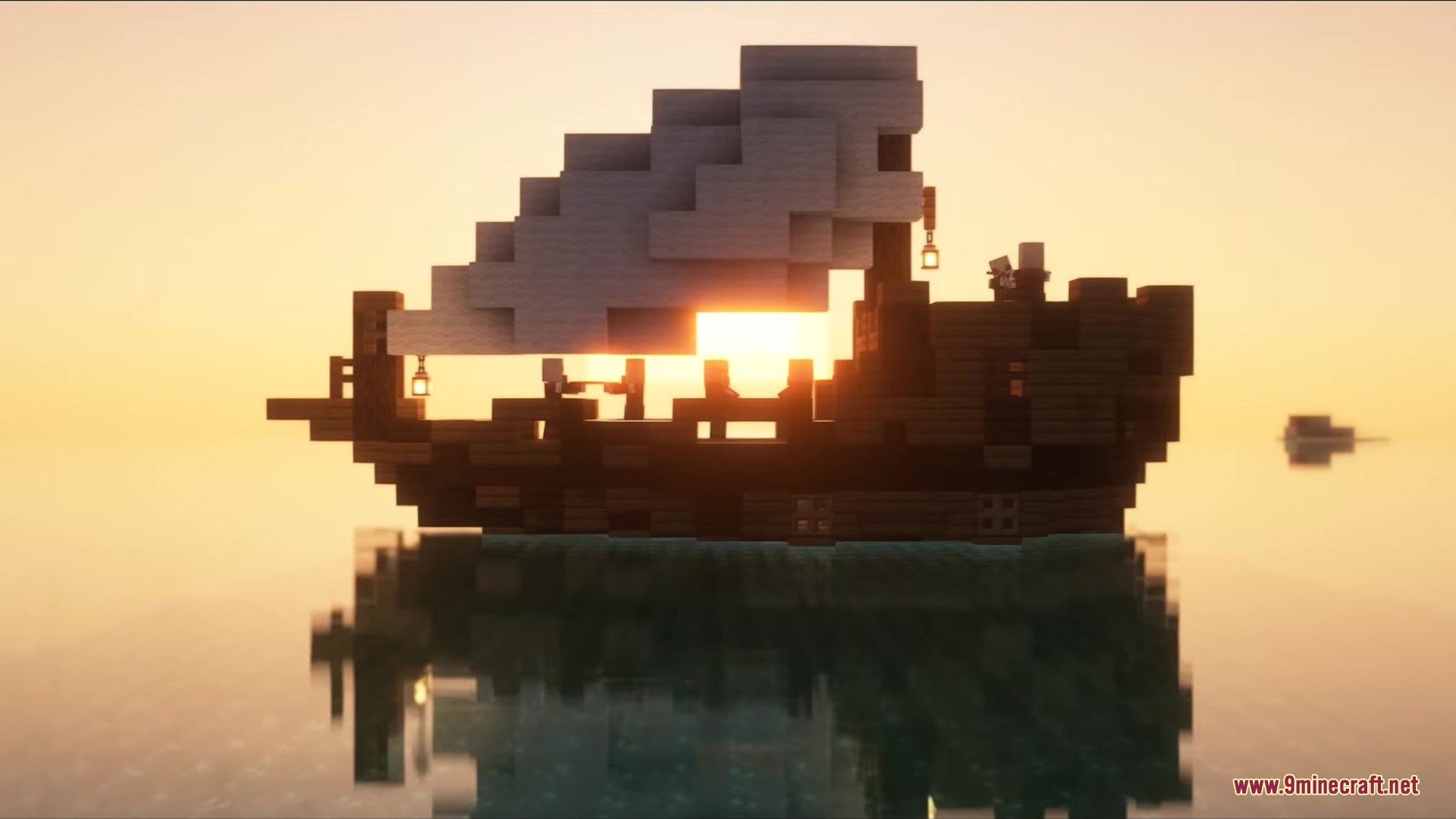 A small wooden ship with white sails sailing on the ocean during sunset