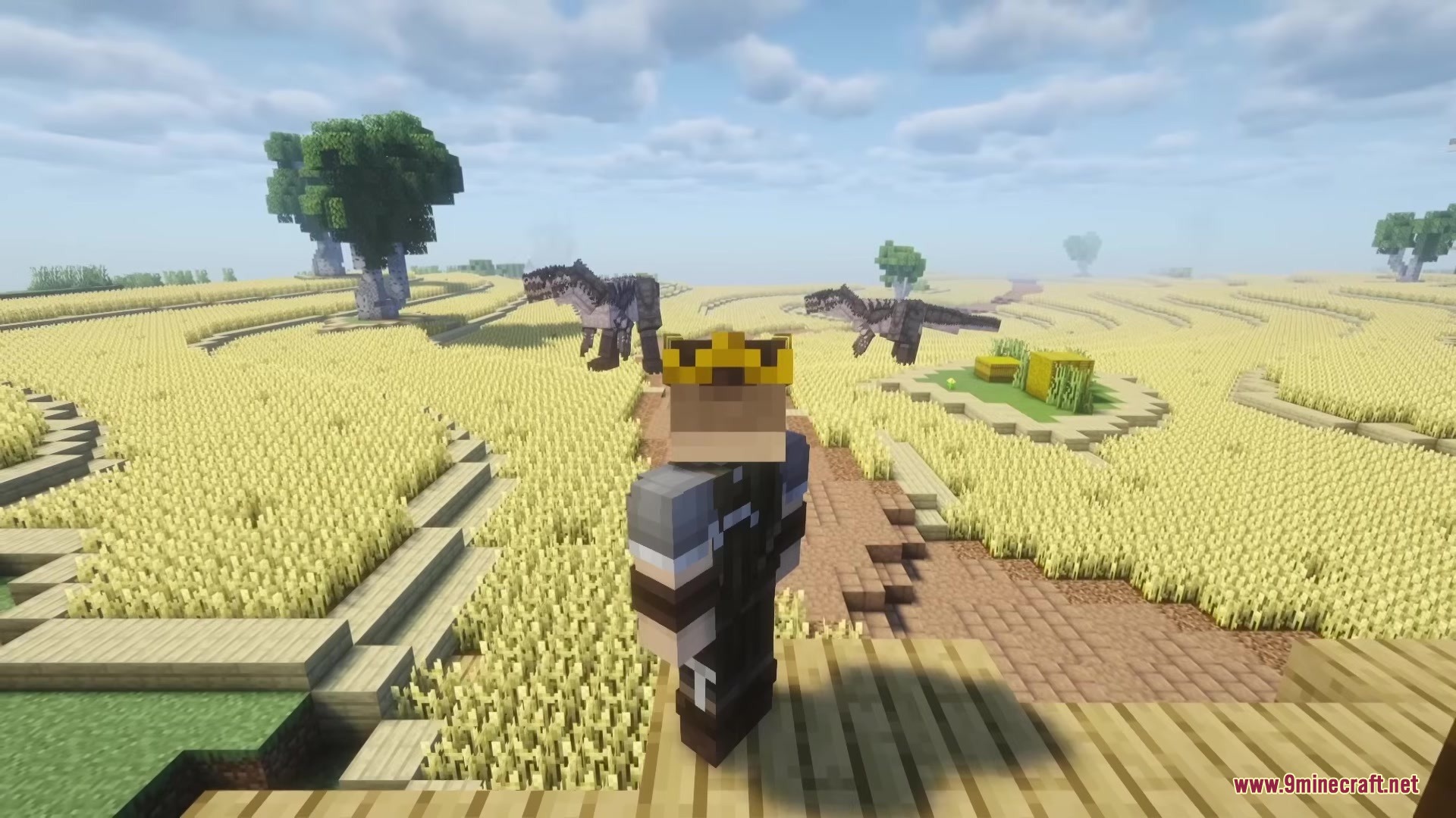 Two large dinosaurs stalk a player wearing a crown in a wheat field