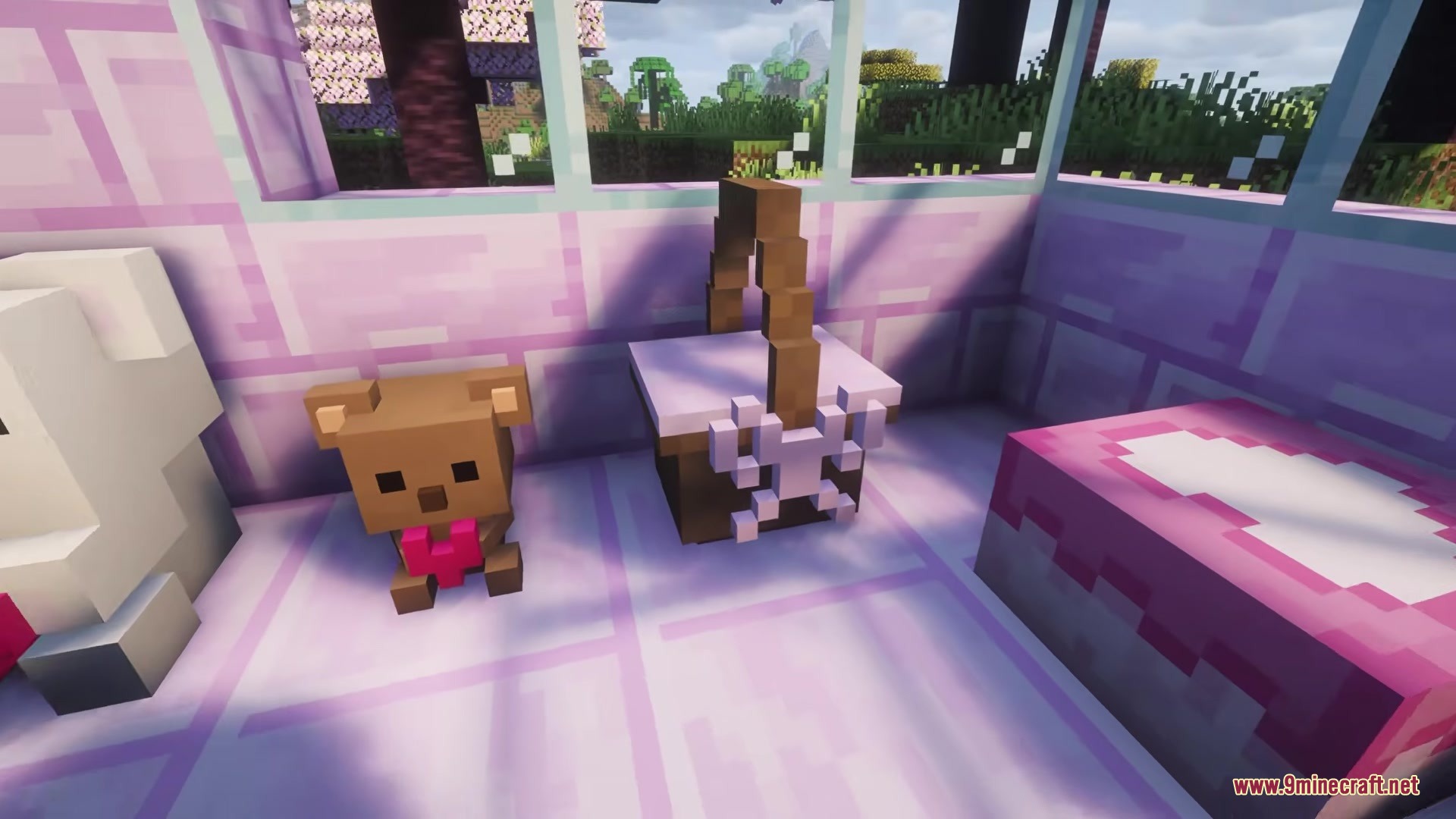 A brown teddy bear plushie holding a pink heart next to a picnic basket