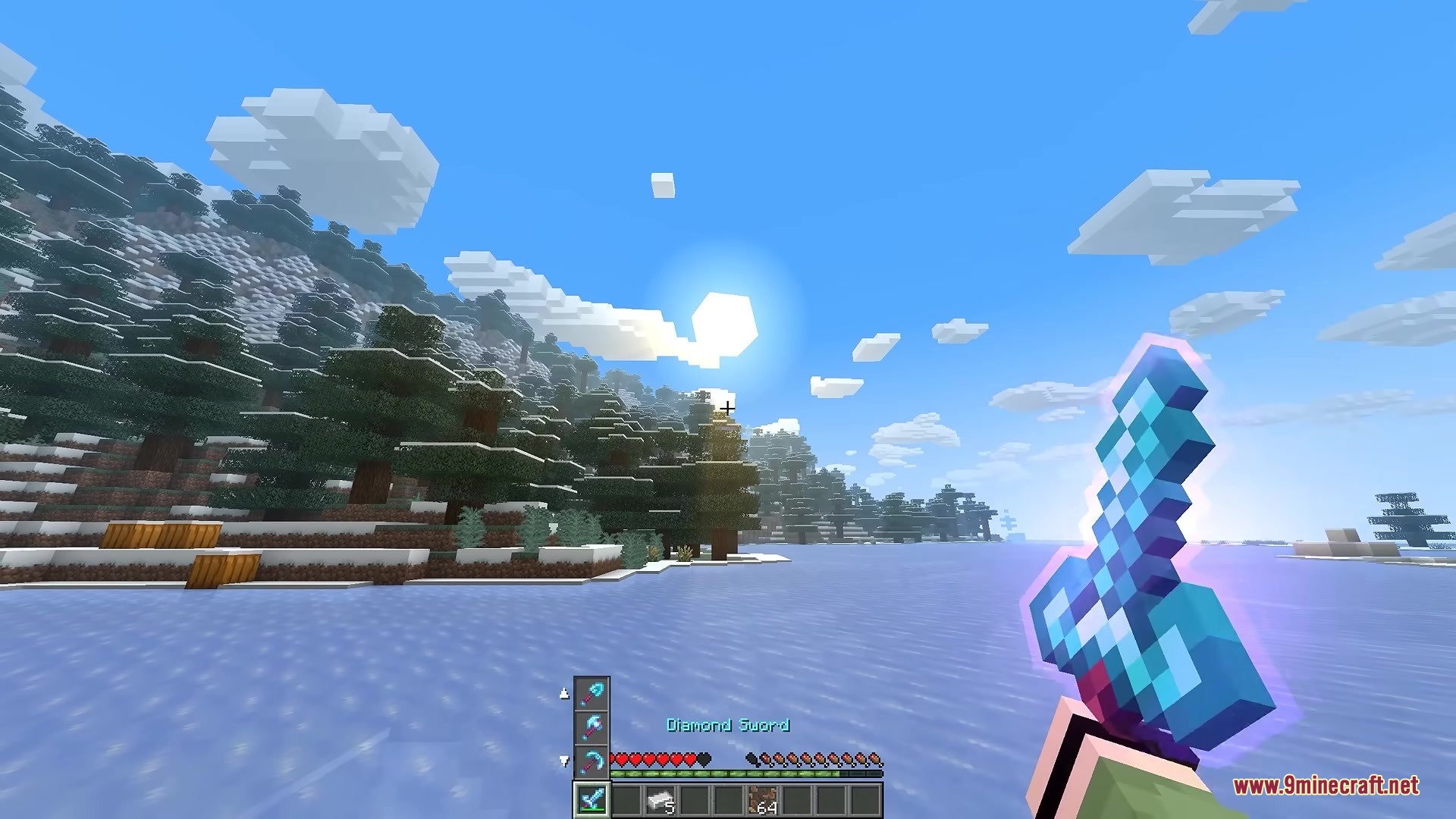Player holding an enchanted diamond sword in a snowy forest biome