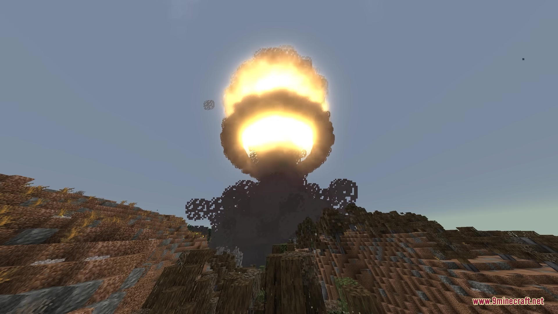 WMD Weapons of Mass Destruction Mod Screenshot 8 Massive nuclear explosion creating a bright mushroom cloud over a hilly Minecraft landscape