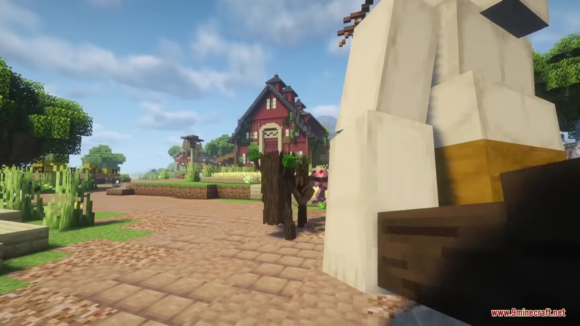 Wandering Orc Mod Screenshot 12 A wooden treant creature walks through a village path toward a red house