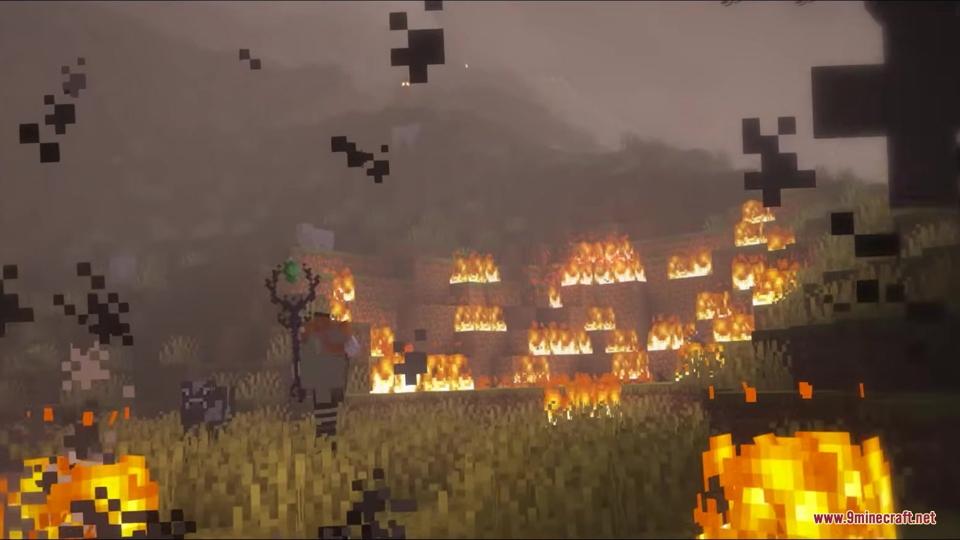 Wandrous Mod Screenshot 11 A player holding a magic staff stands among fire and dark particles