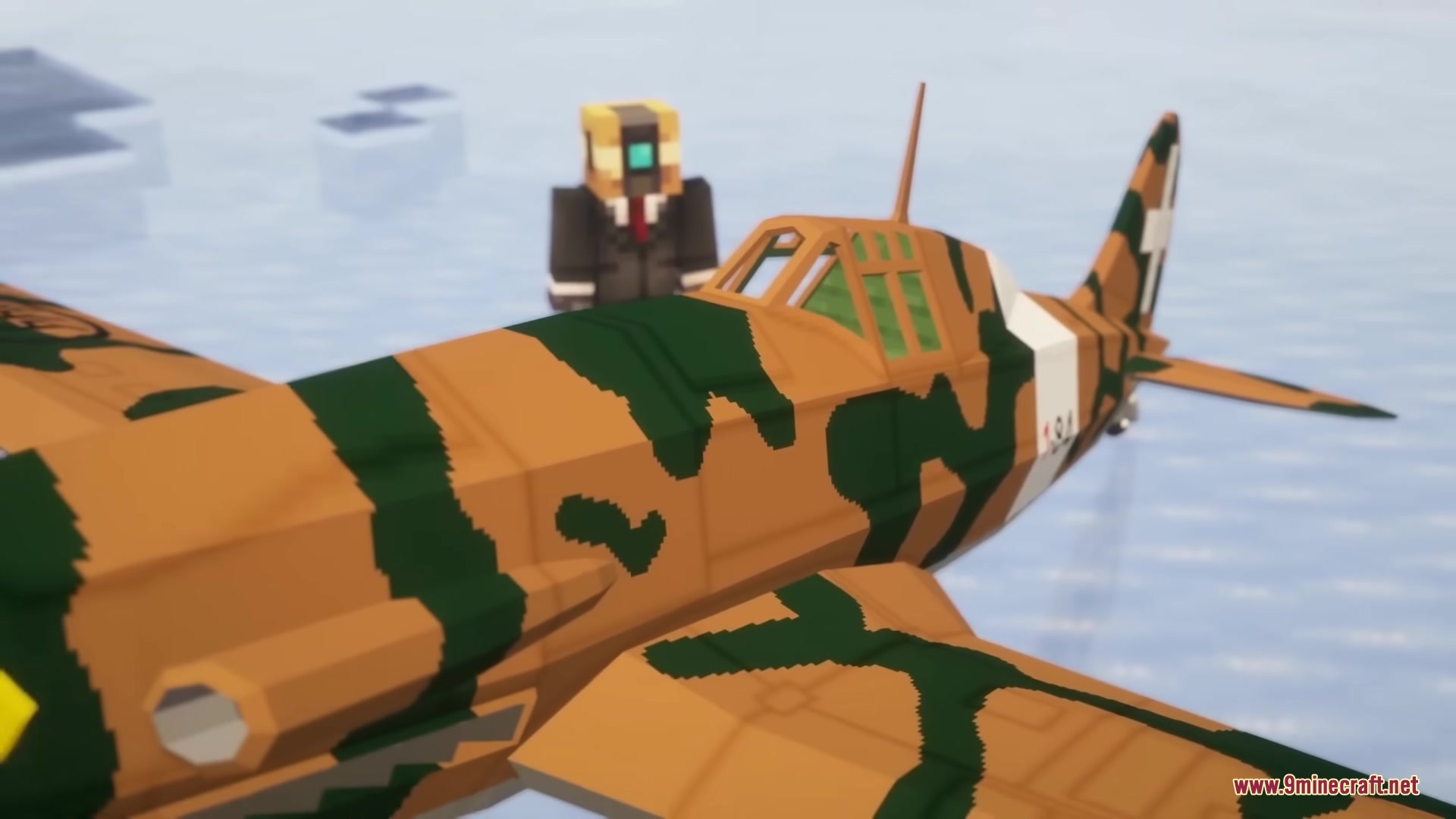 Warfare Wings Mod Screenshot 18 A player stands next to a camouflaged plane from the Warfare Wings mod