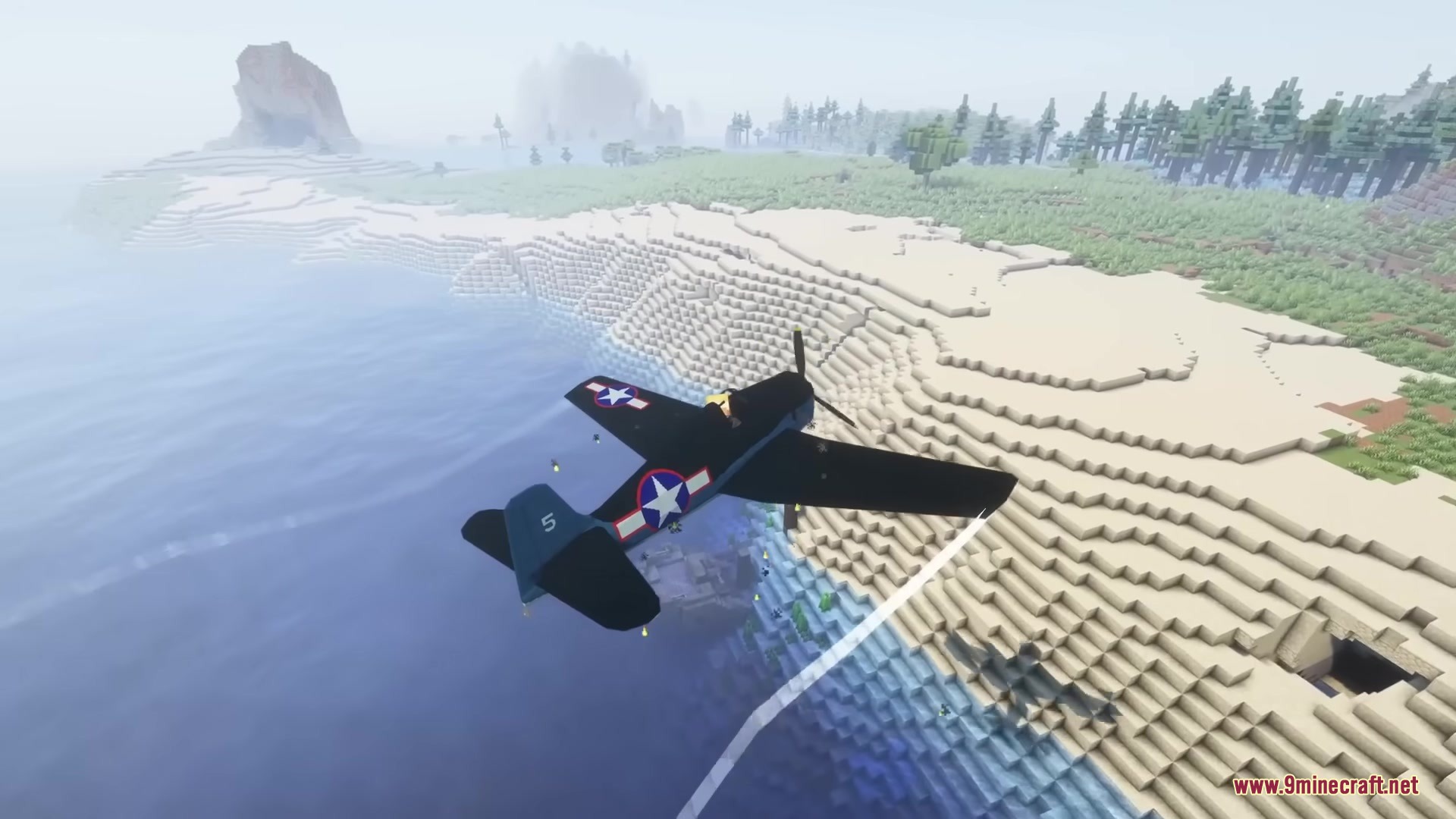 Warfare Wings Mod Screenshot 4 A dark blue American fighter plane soaring over a Minecraft beach and ocean