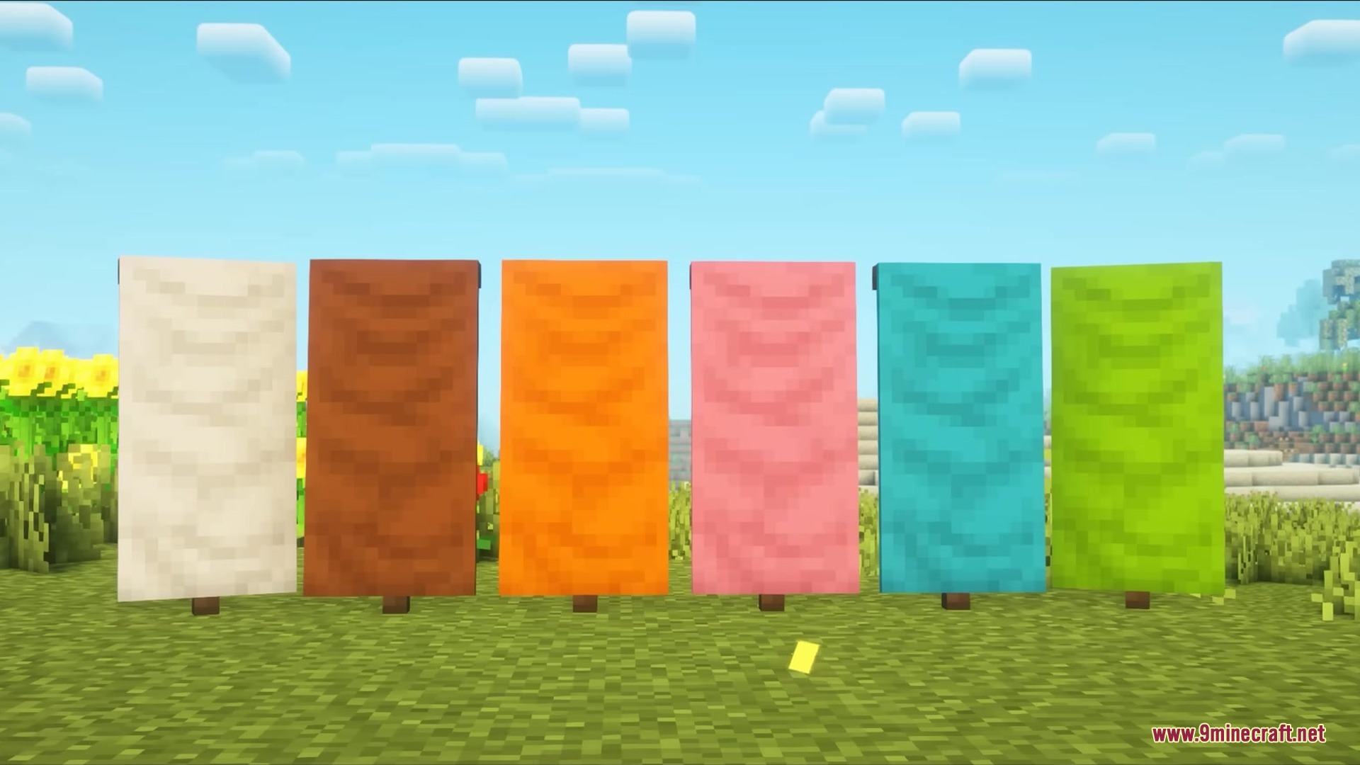 Showcase of colorful Wavy Banners standing in a row on a grassy field