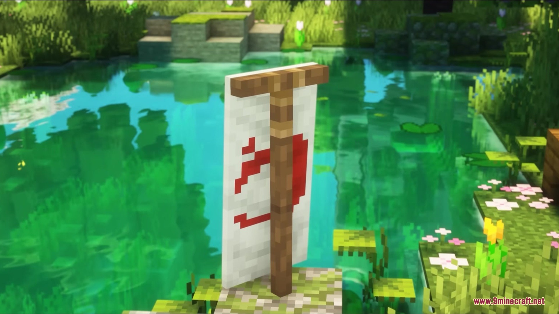 A white banner with a red pattern on a wooden post near water