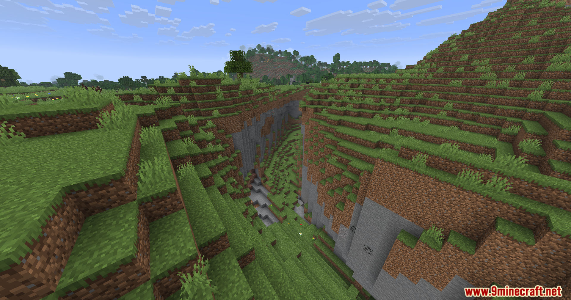 WayGL Mod Screenshot 5 A deep ravine cutting through a lush green grassy hill landscape