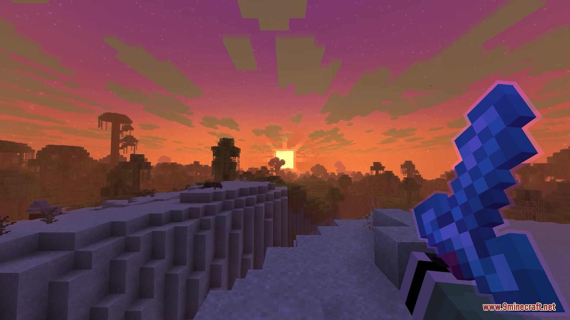 Waylight Mod Screenshot 5 Player holding an enchanted blue sword while watching a beautiful sunset in Minecraft