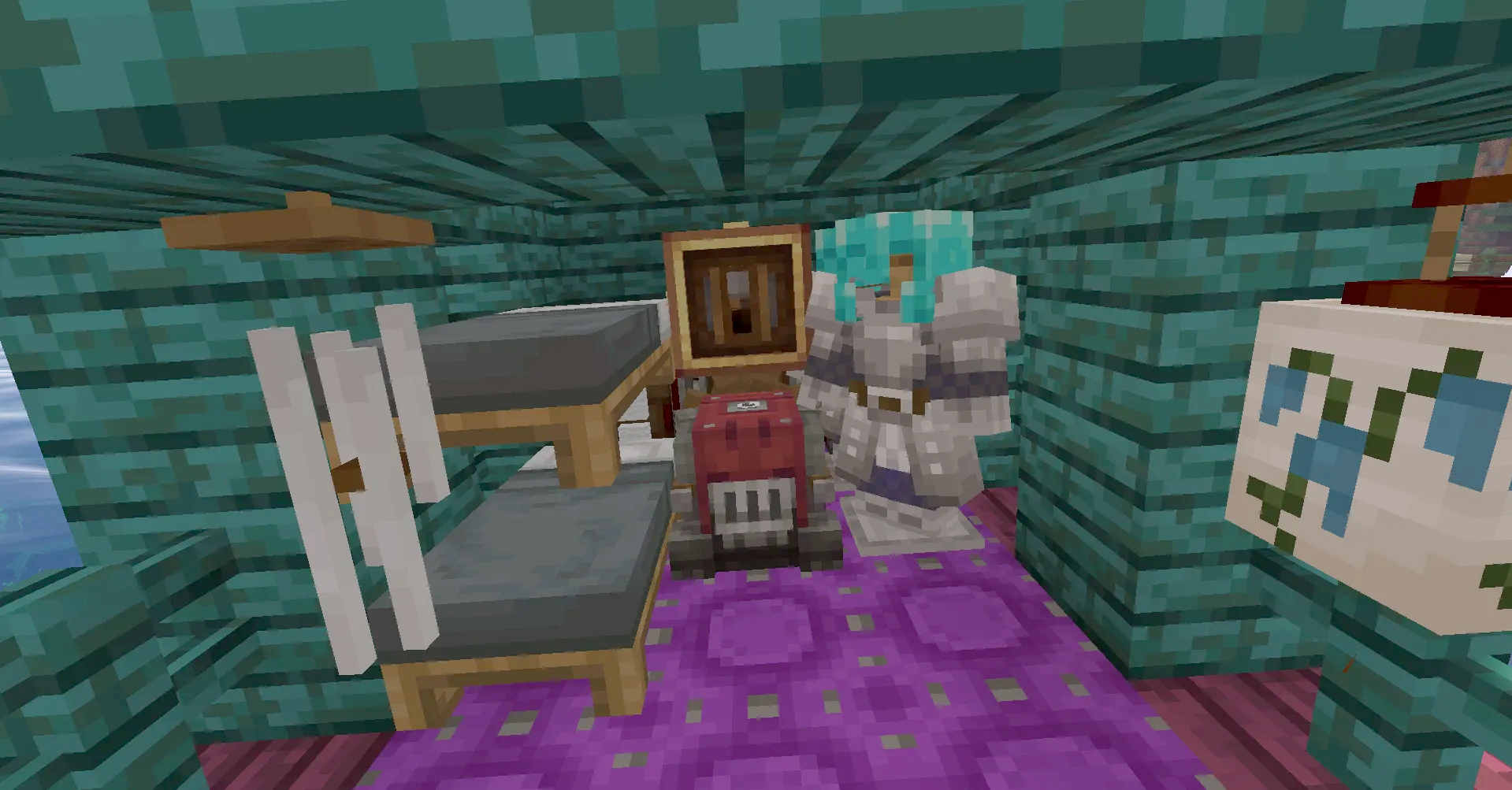 Bunk beds and an armor stand inside a small teal wooden ship cabin