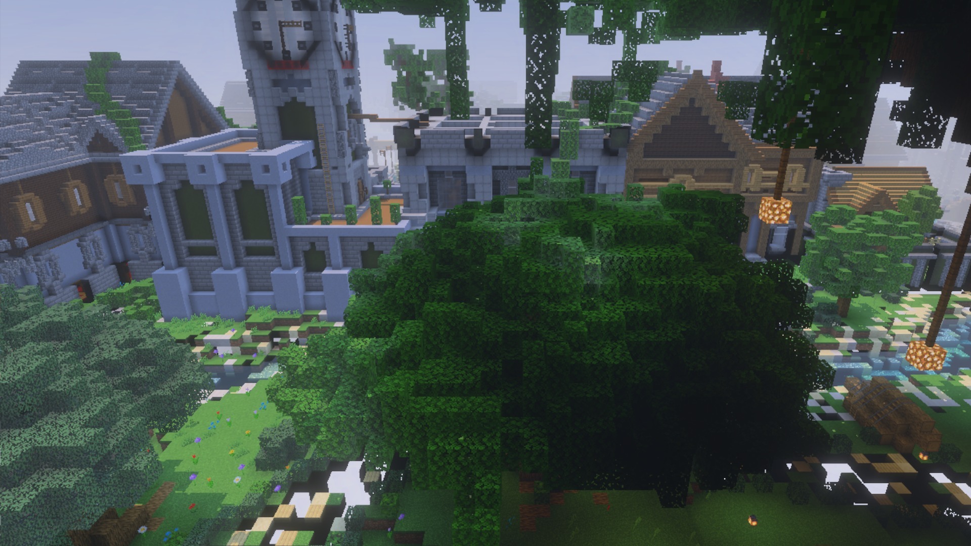 A Minecraft village with stone buildings and a tall clock tower