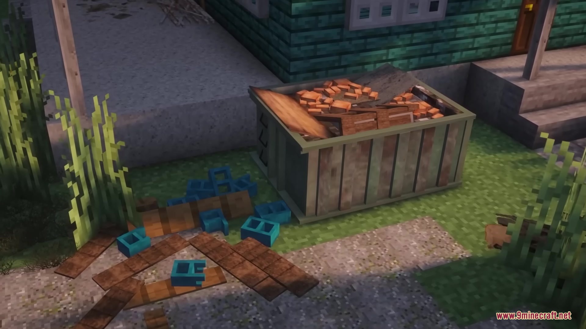 Green dumpster filled with construction waste near scattered blue cinder blocks