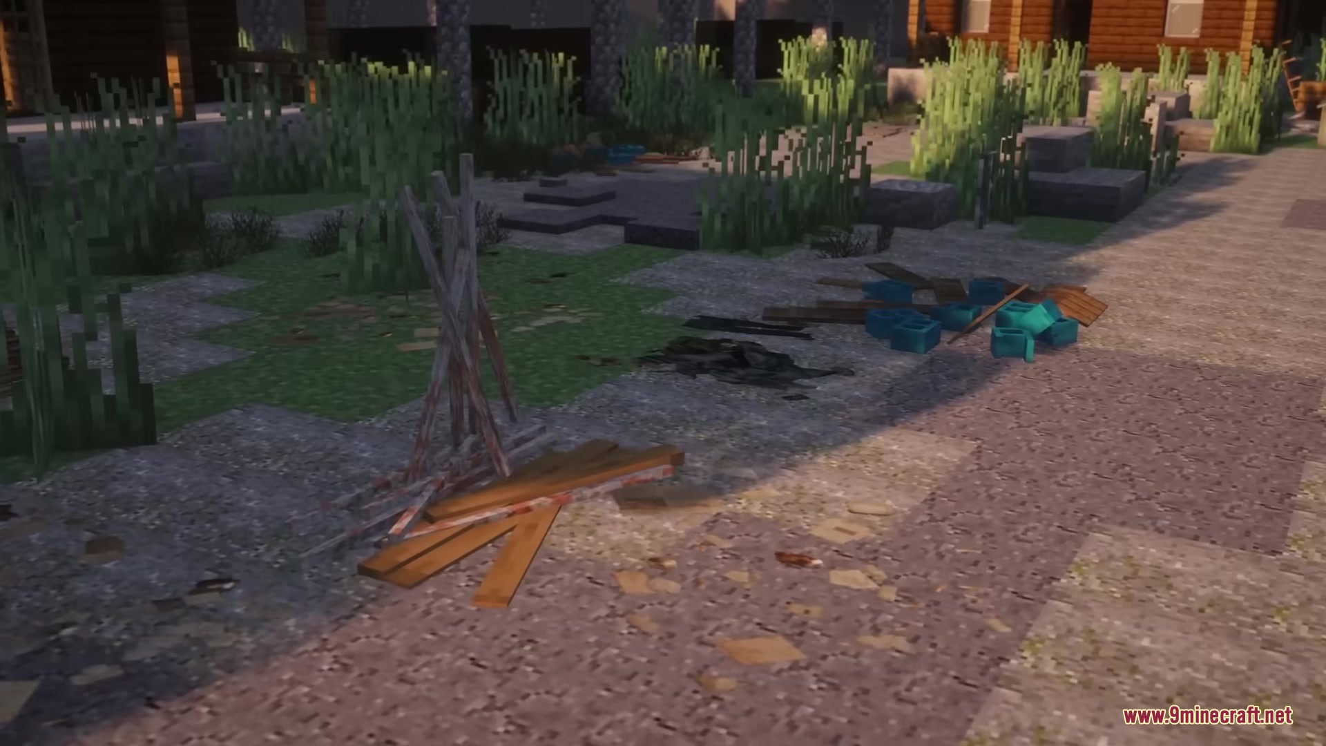 Broken wooden planks and blue cinder blocks scattered on a gravel path