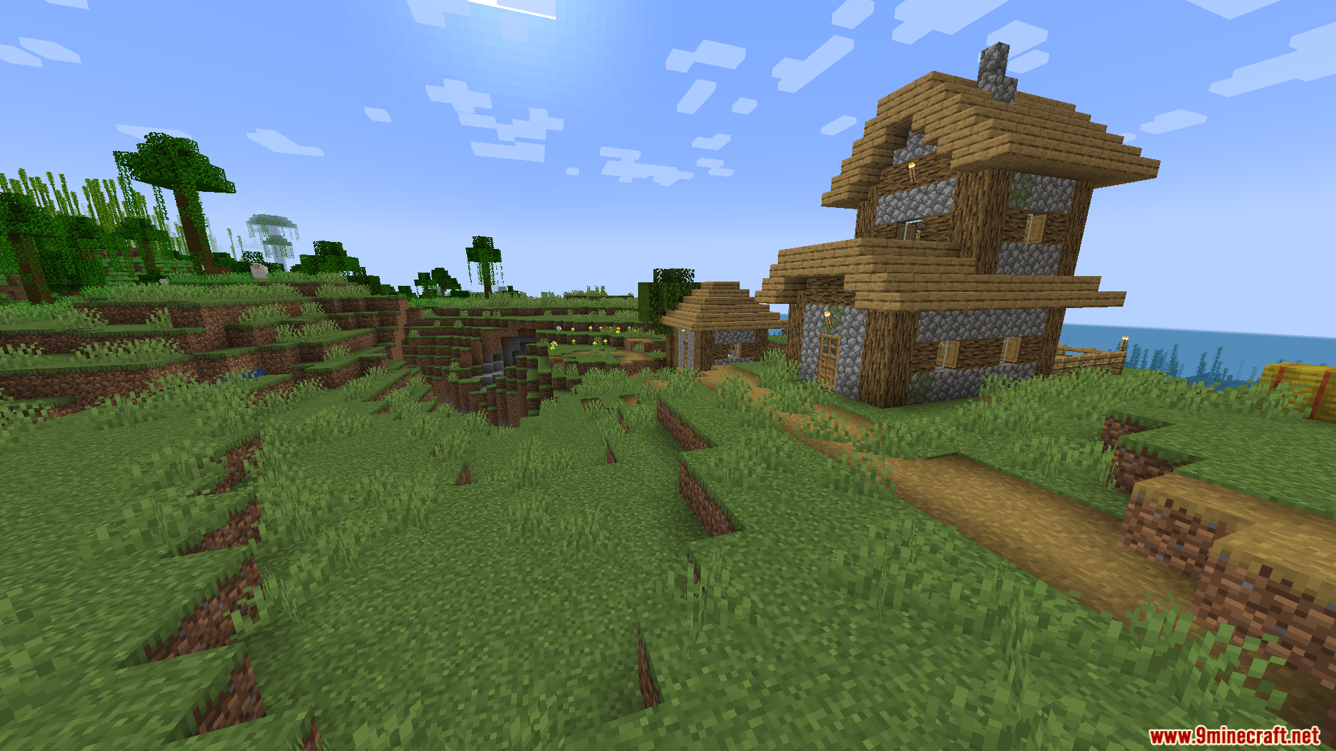 Zenith Attributes Spanish Translation Resource Pack Screenshot 9 A two story wooden and cobblestone house stands on a grassy hill