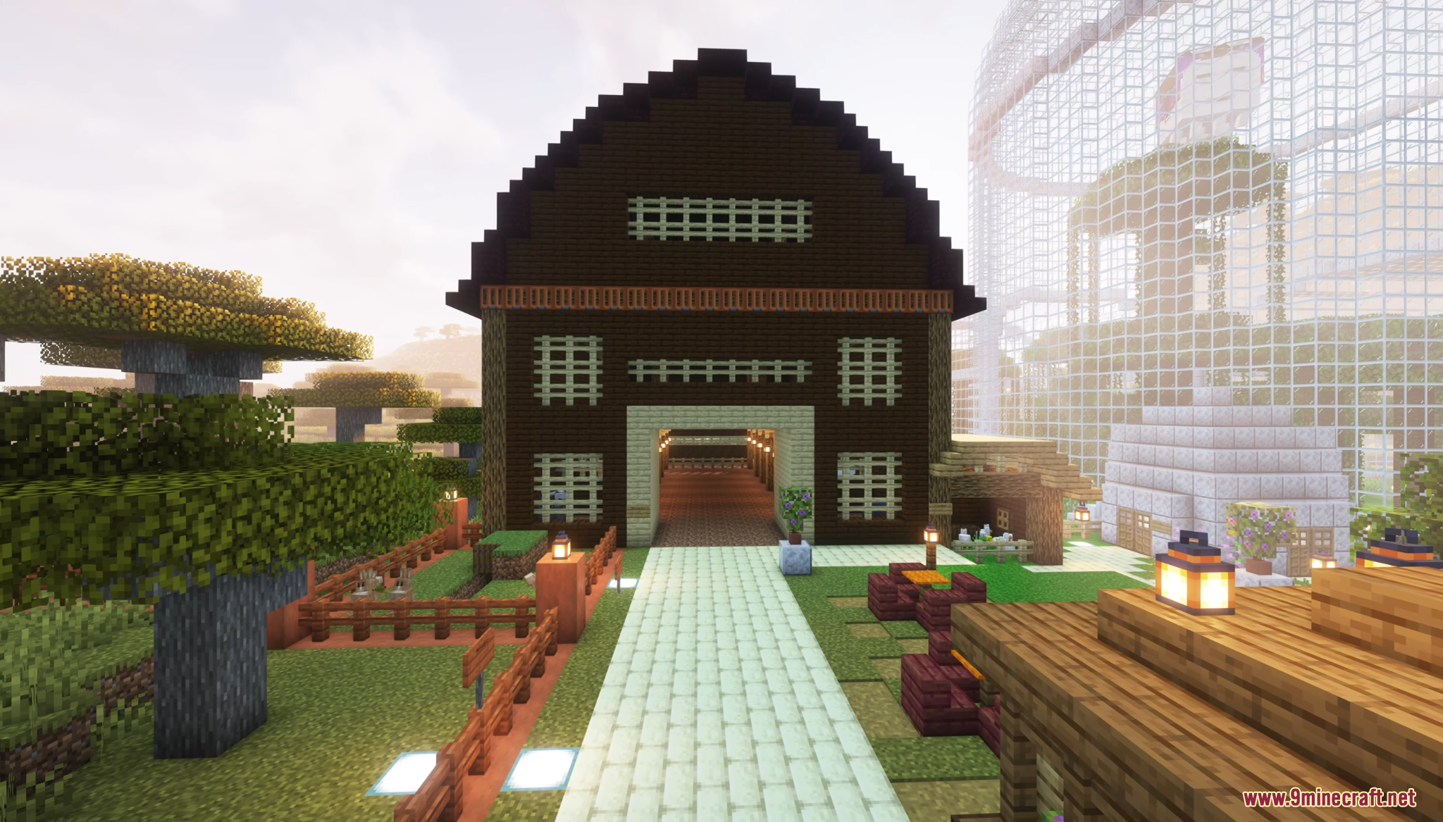 Large wooden barn structure with a stone path in a Minecraft zoo