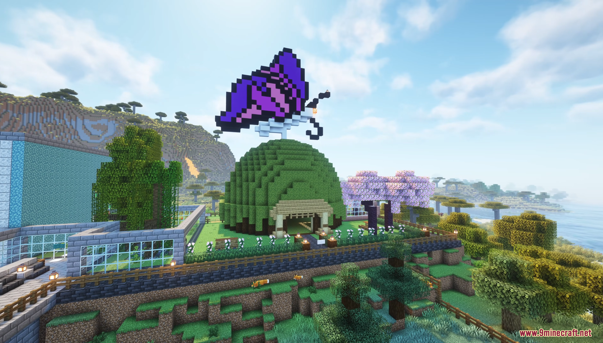 A green dome building with a large purple butterfly pixel art on top