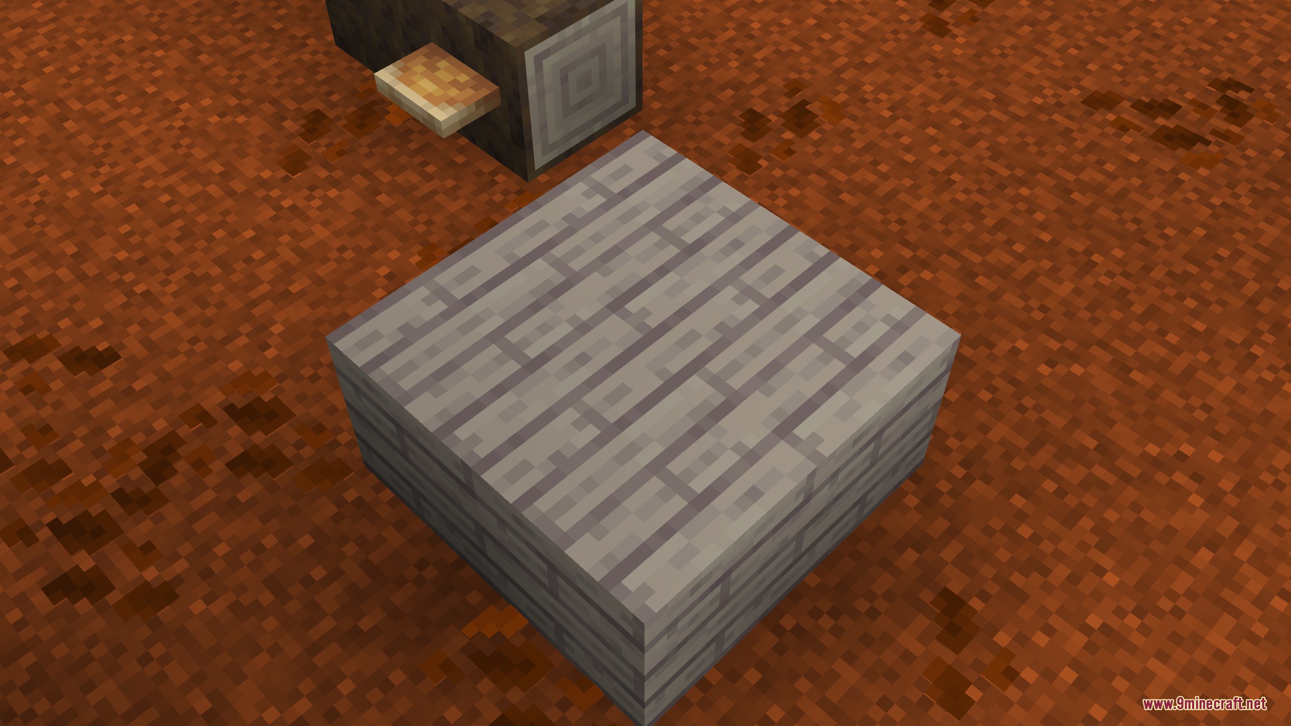 A block of light gray wooden planks placed on reddish dirt ground