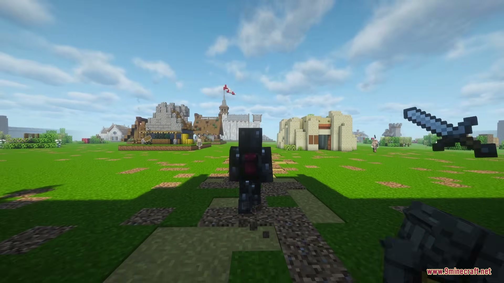 A Game of Blocks Mod Screenshot 11 A player in dark armor stands near medieval buildings in a grassy field