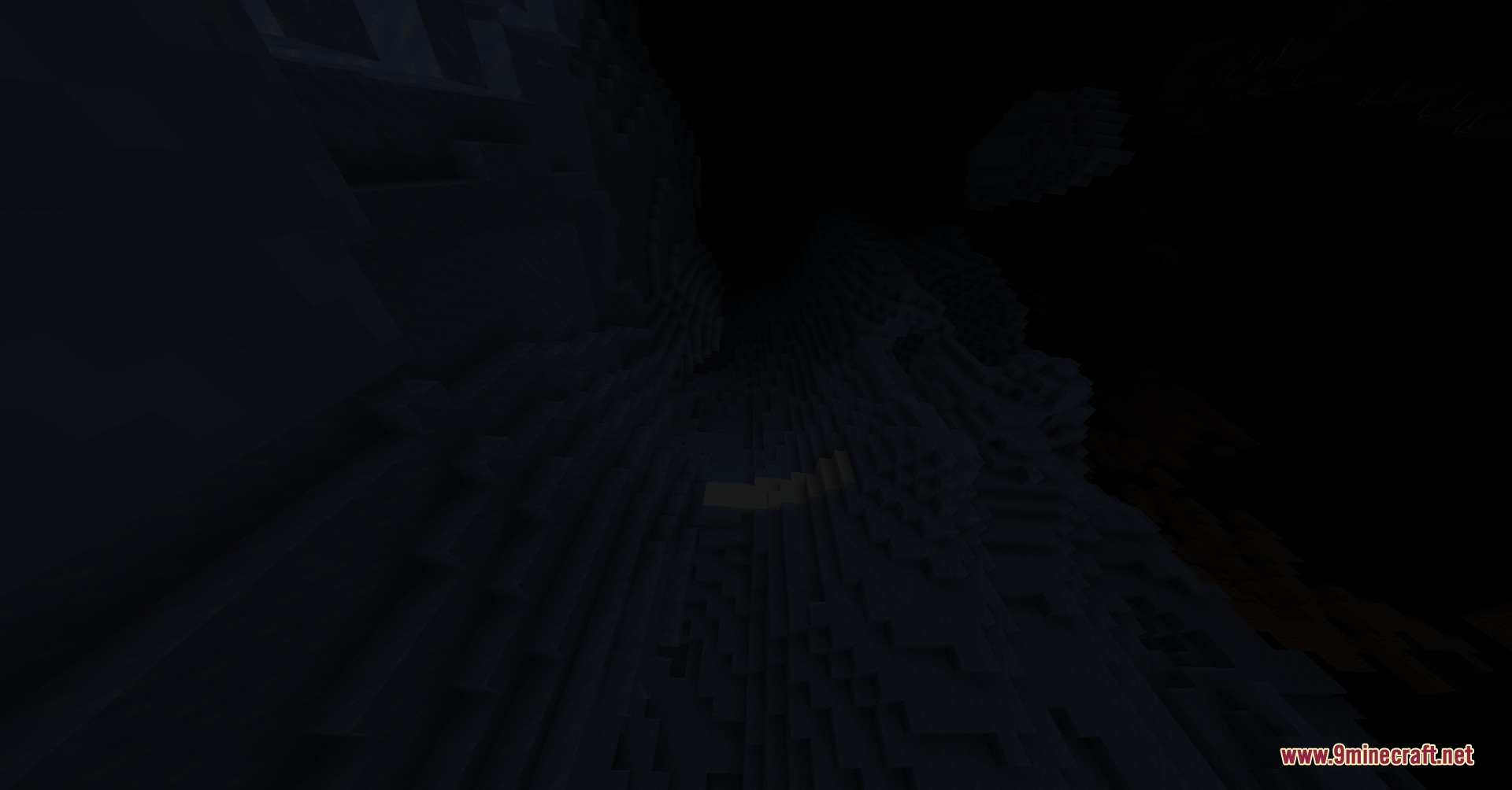 A deep and narrow shaft descends into the darkness of the abyss