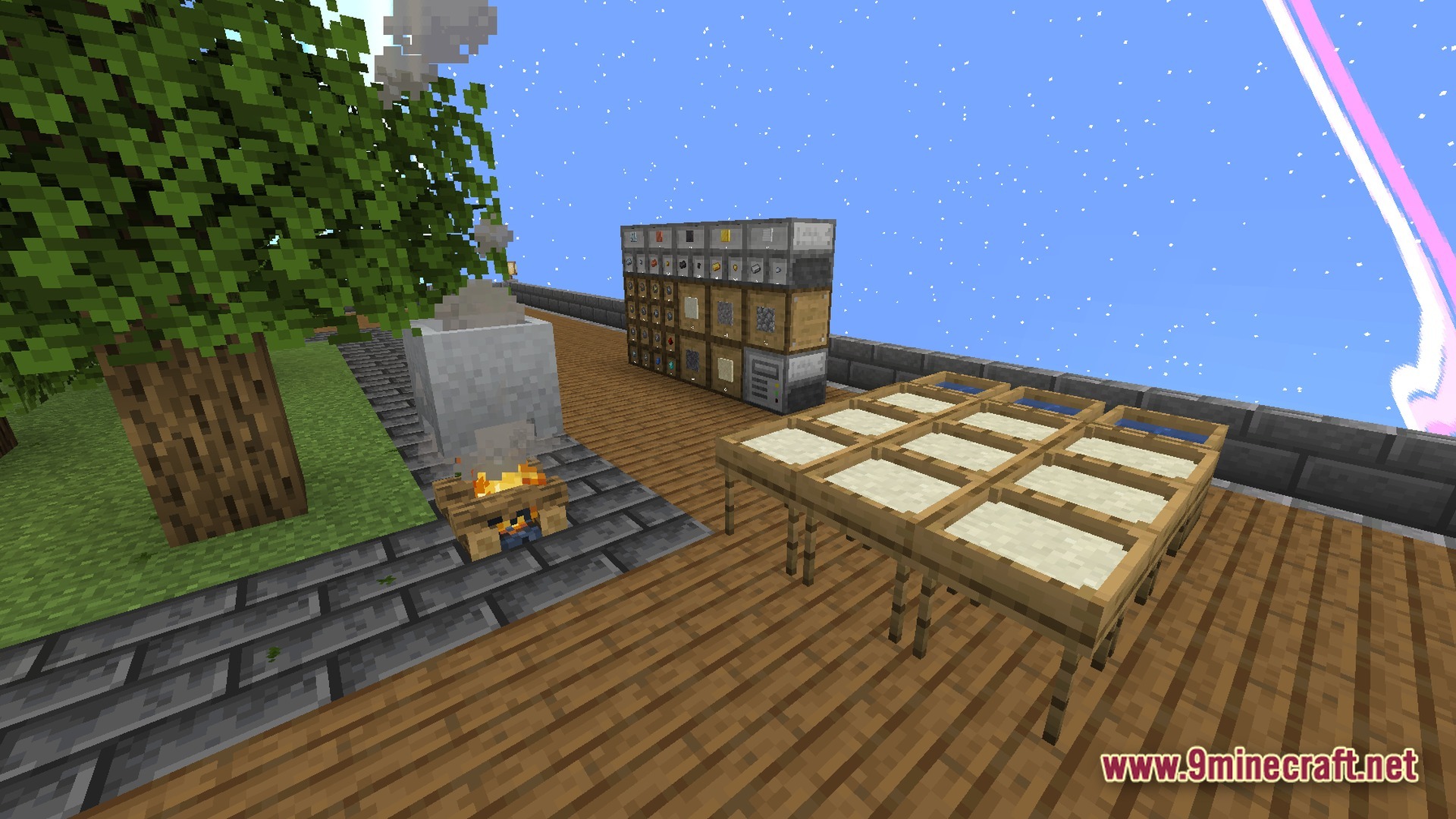 Aetheric Infinity Zenith Modpack Screenshot 8 A campfire, stone cauldron, drying racks, and storage drawers on a wooden platform under a blue sky