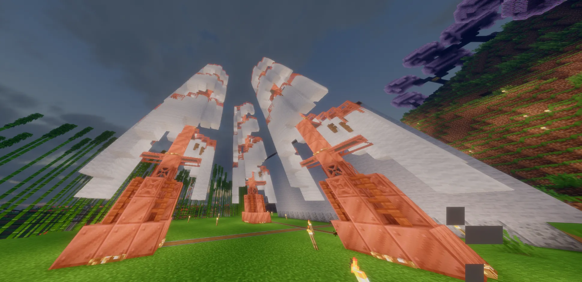Vertical Windmill Schematic Screenshots 2 Several tall Vertical Windmill Schematic builds standing in a grassy field under clouds