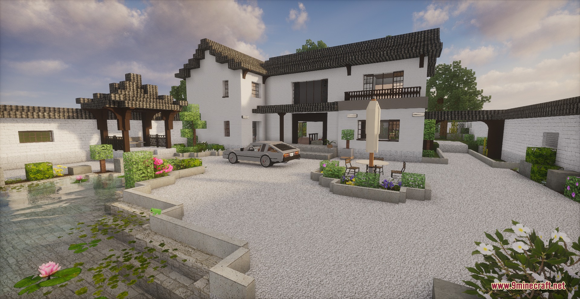 Modern white villa with a courtyard featuring a car and garden pond