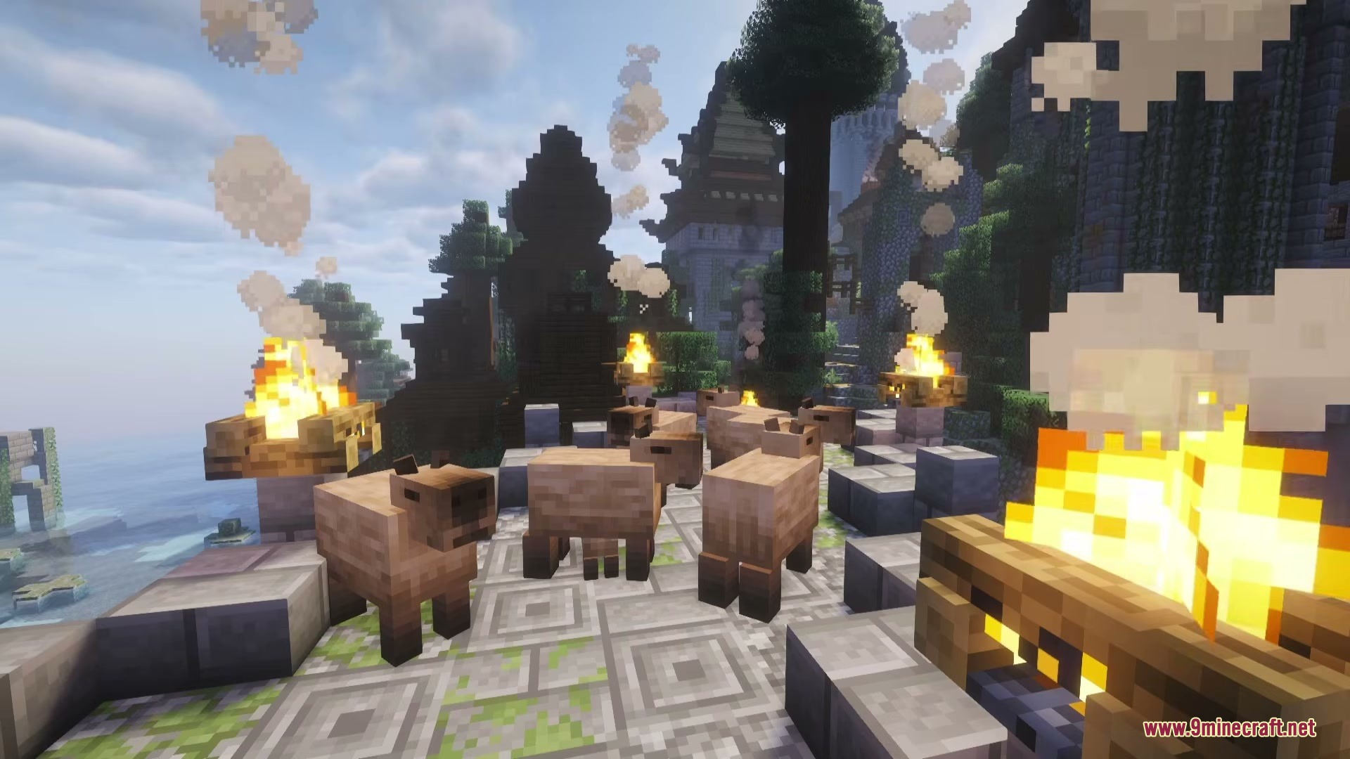 Capybaras gathered on a stone path surrounded by several burning campfires