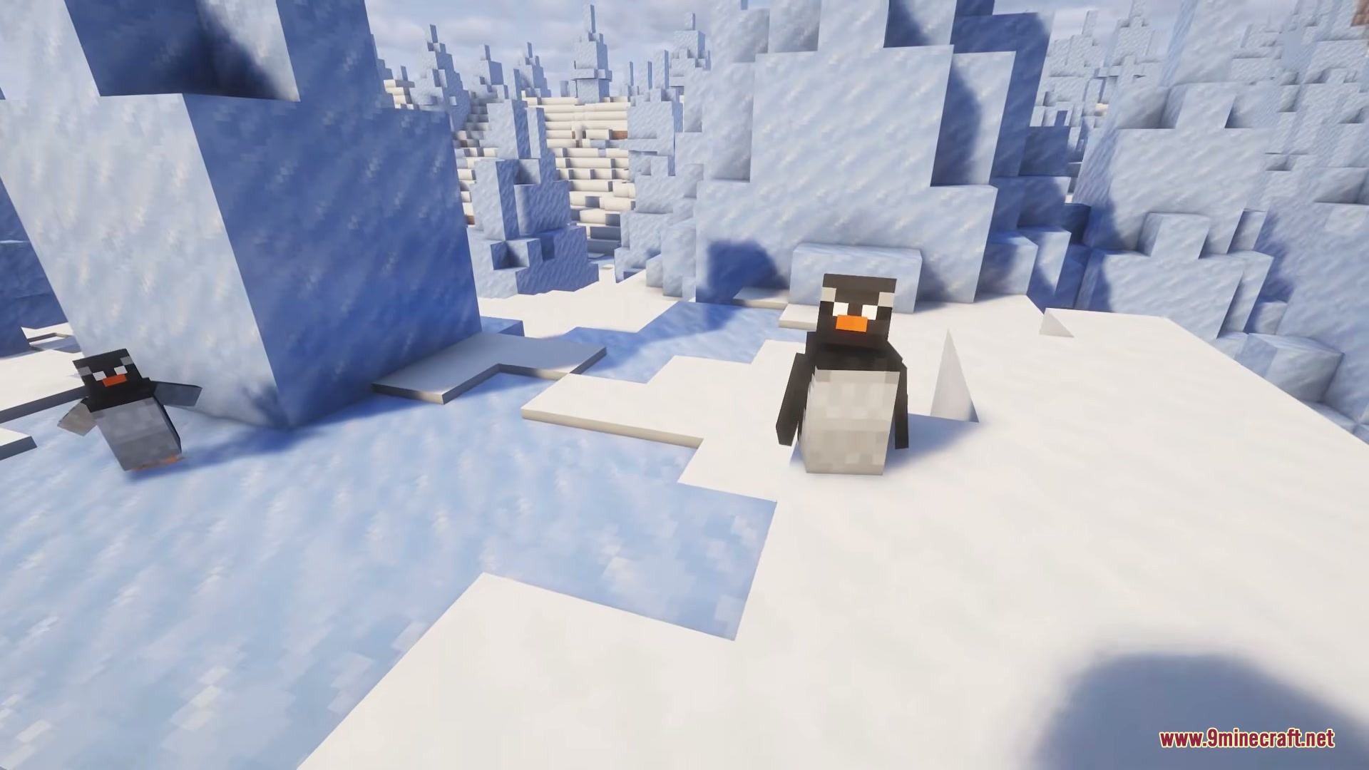 Two penguins standing on snow and ice in a frozen biome