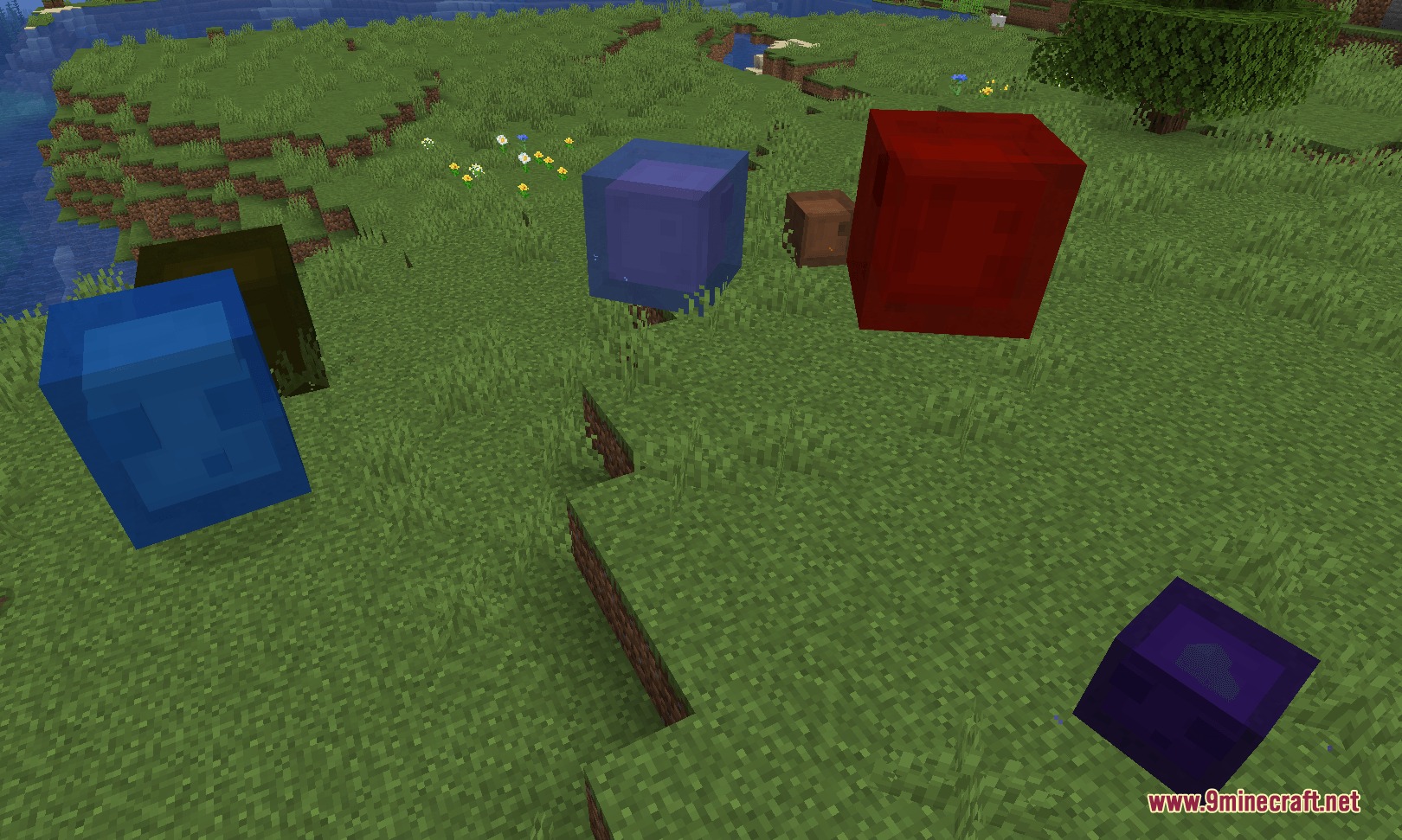 Amphibian Alchemy Mod Screenshot 2 Various colored slimes including blue and red ones on a grassy field