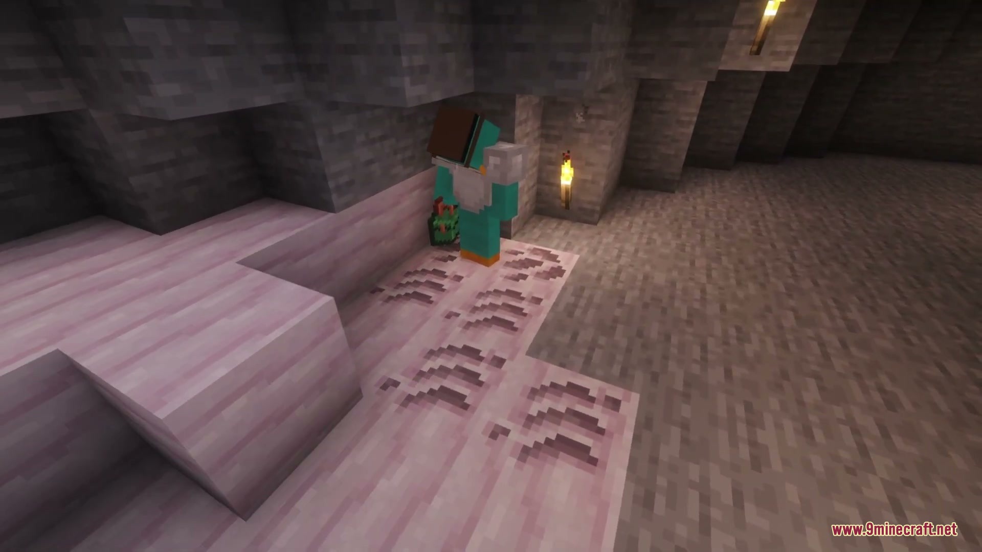 A player stands near prehistoric fossil blocks inside a dark stone cave