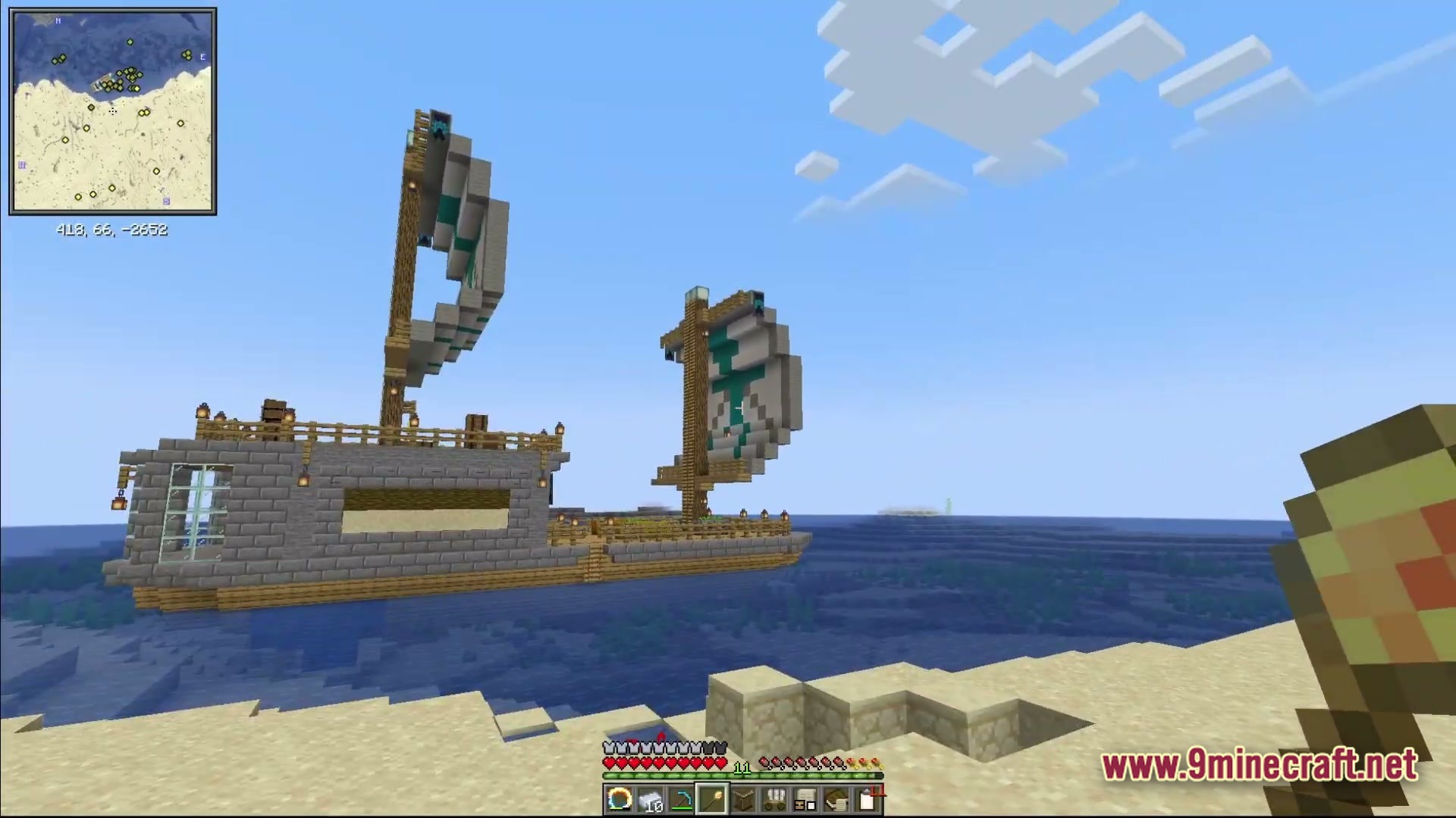 Ancient Kingdoms 3 Modpack Screenshot 3 A large stone and wood sailing ship anchored in an ocean biome near a sandy beach
