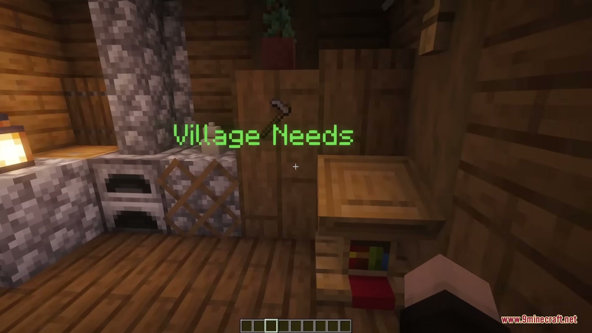 A floating green sign saying Village Needs above a wooden lectern station