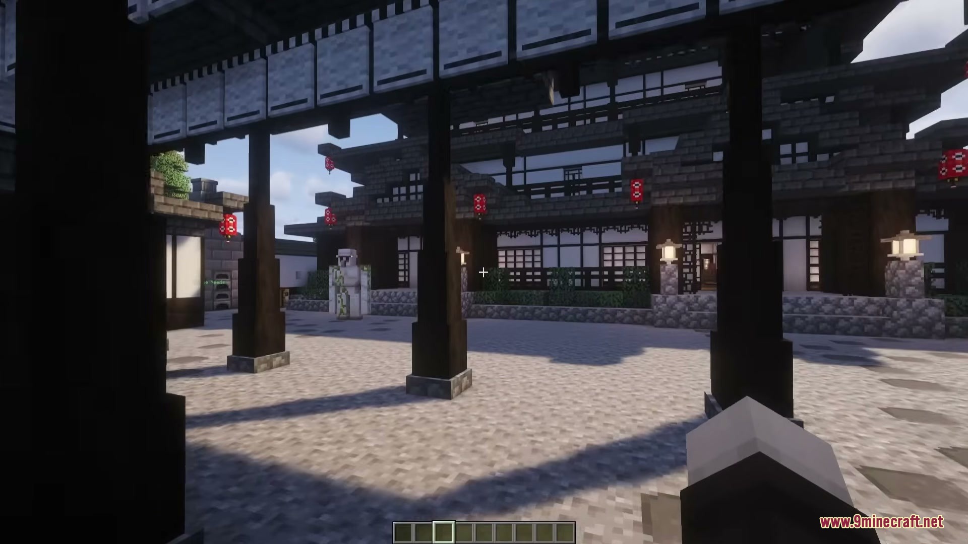 A player explores a traditional Japanese style village courtyard with an iron golem