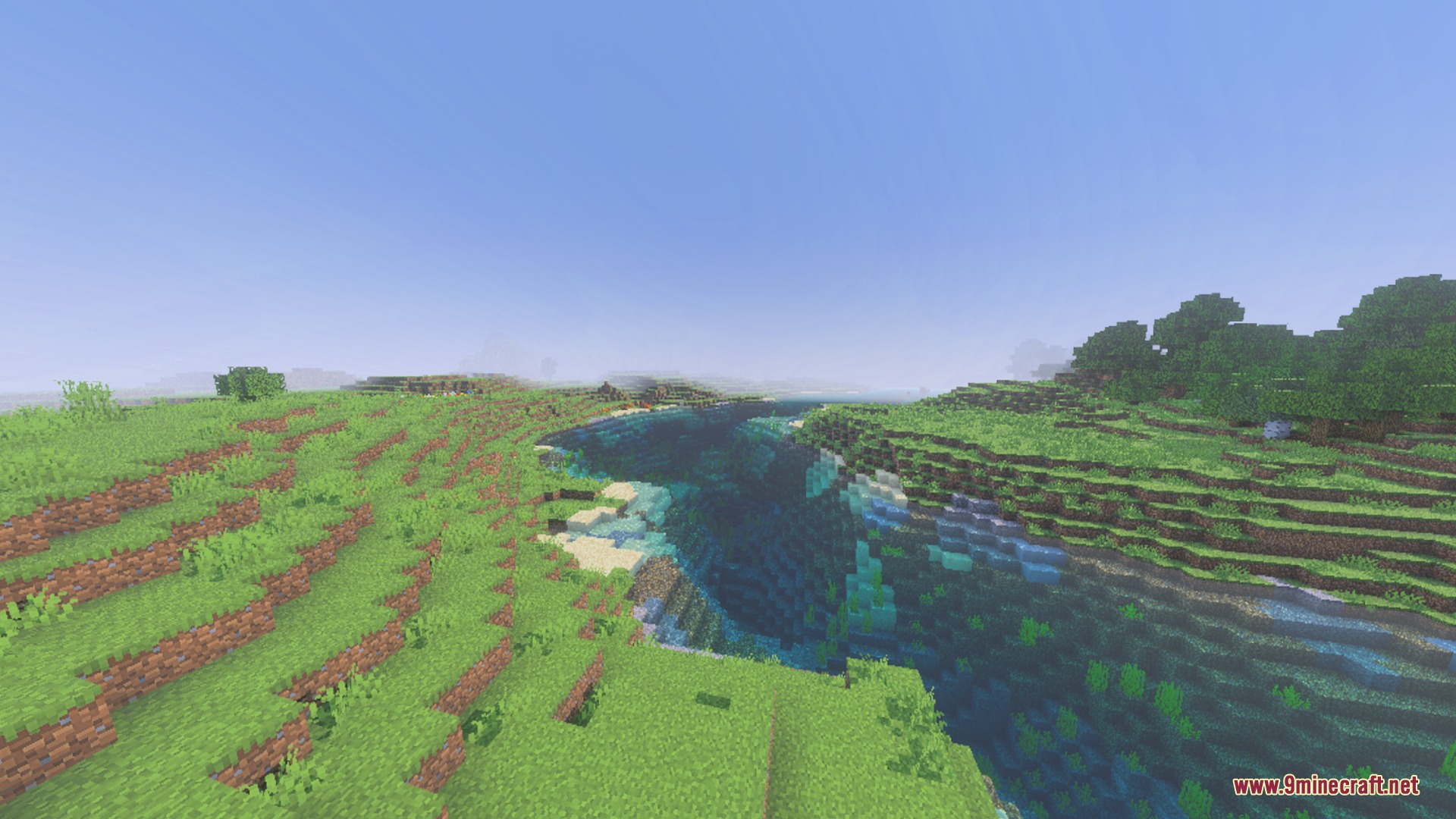 Lush green hills and clear blue water in a bright Minecraft landscape