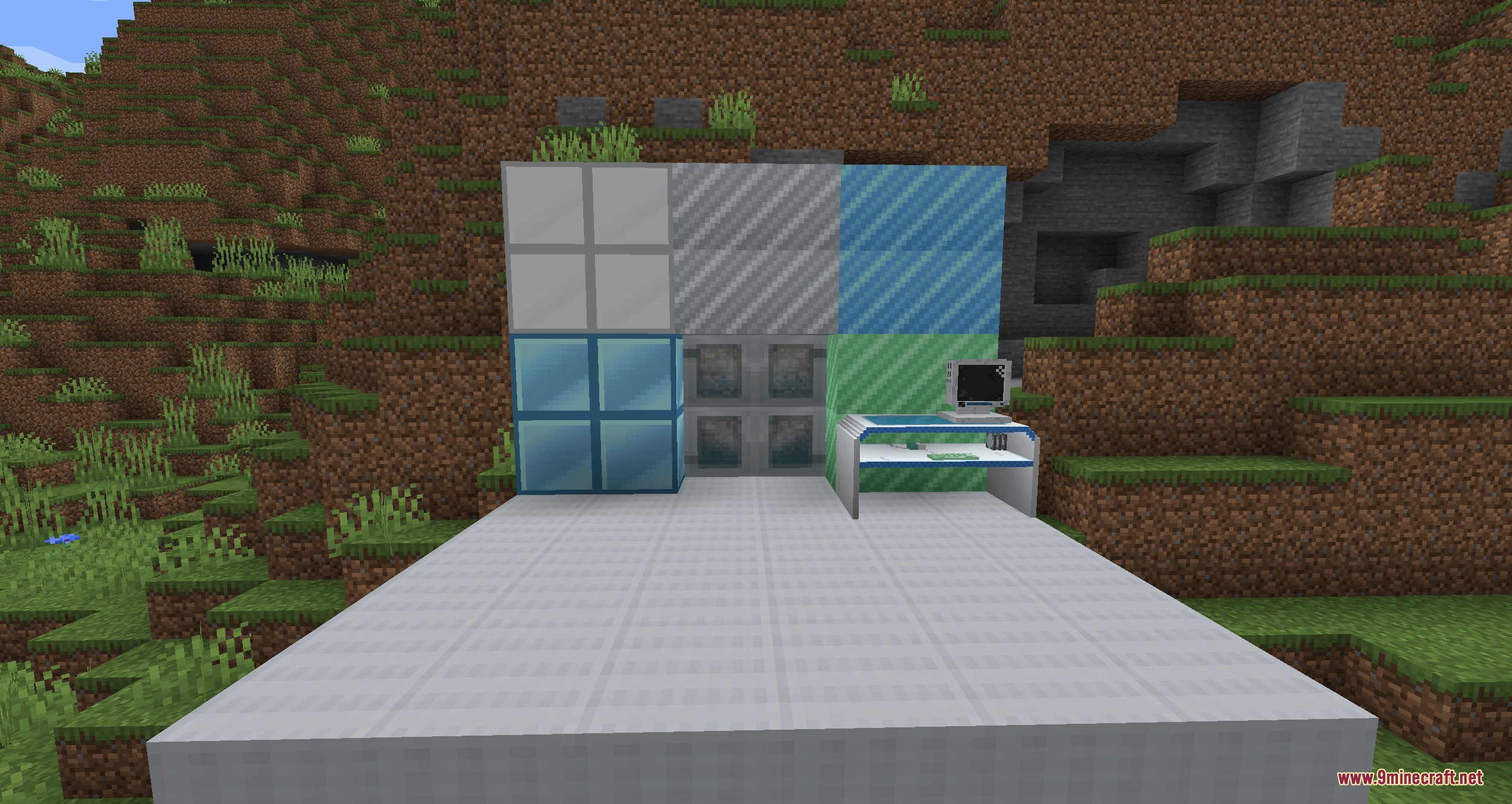 A retro futuristic computer workstation with custom blocks in a Minecraft landscape