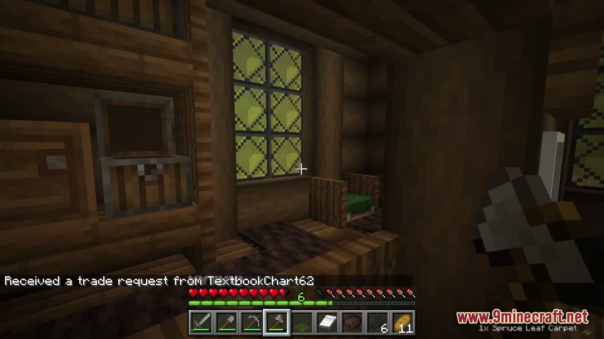 Arcanum Land Modpack Screenshot 6 A wooden interior featuring stained glass windows, a small bed, and a storage chest