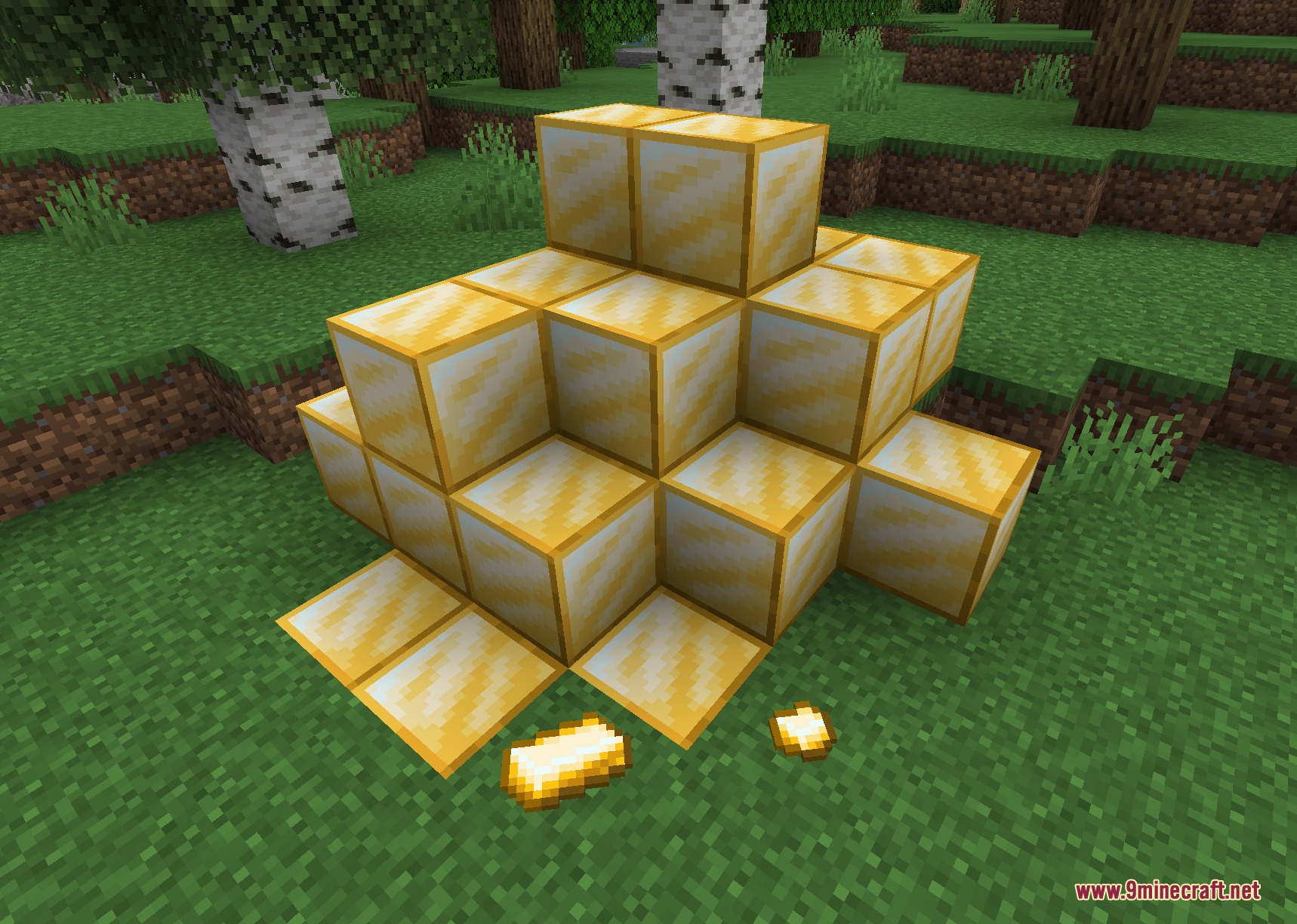 Ascendant Smithing Metals Mod Screenshot 3 A pile of golden Champium blocks and an ingot on the grass