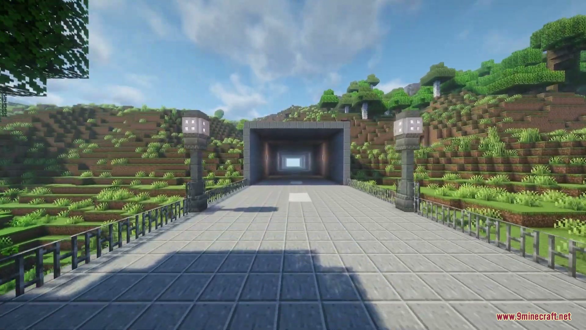 Asphalt Horizon Mod Screenshot 4 A paved road leads into a square tunnel carved through a grassy hill
