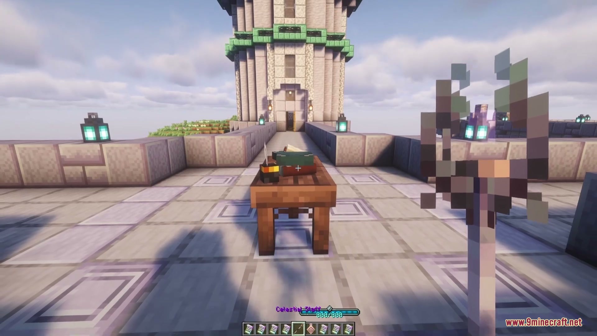 A player holds a Celestial Staff in front of a stone observatory
