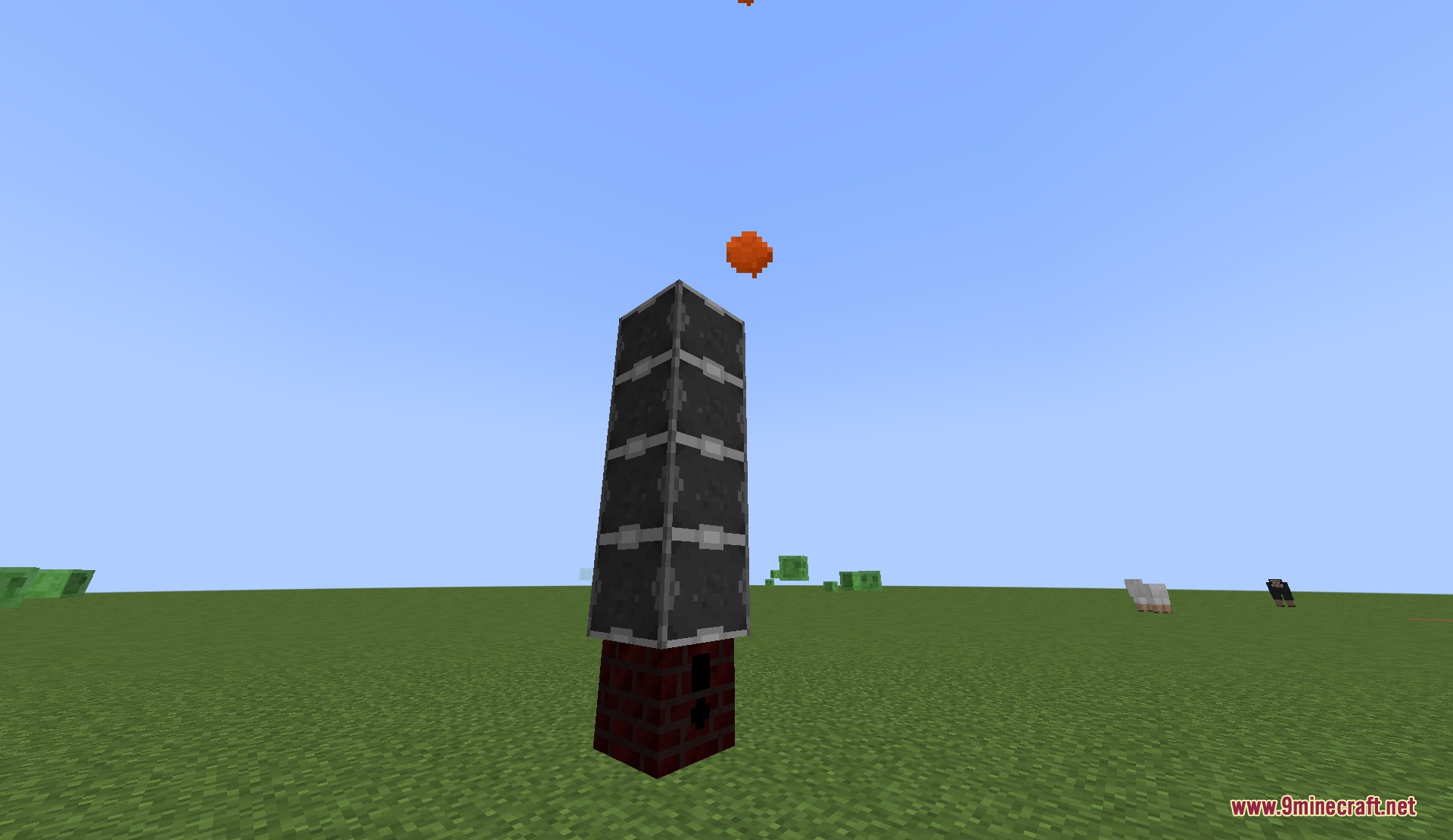 Tall industrial tower structure with orange particles floating above it in Minecraft